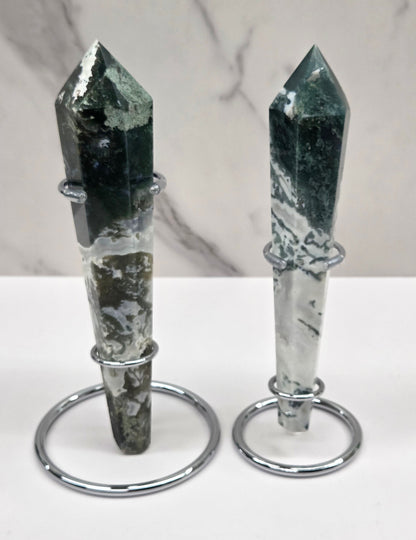 Set of Moss agate wand carvings in silver stands against a white background