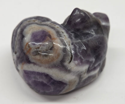 Dream Amethyst sleeping cat carving  with banding on a white background