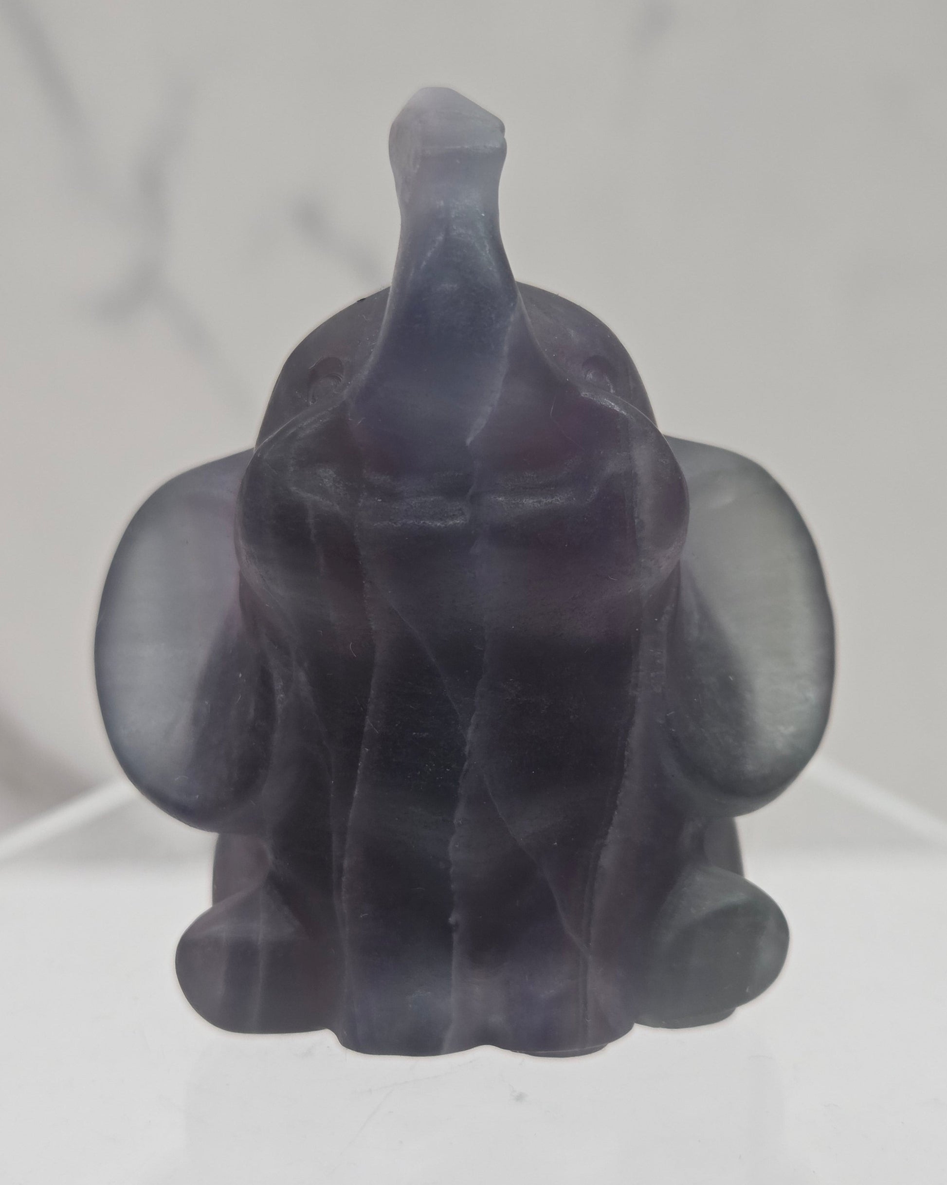Decorative Fluorite sculpture of an elephant on a white background