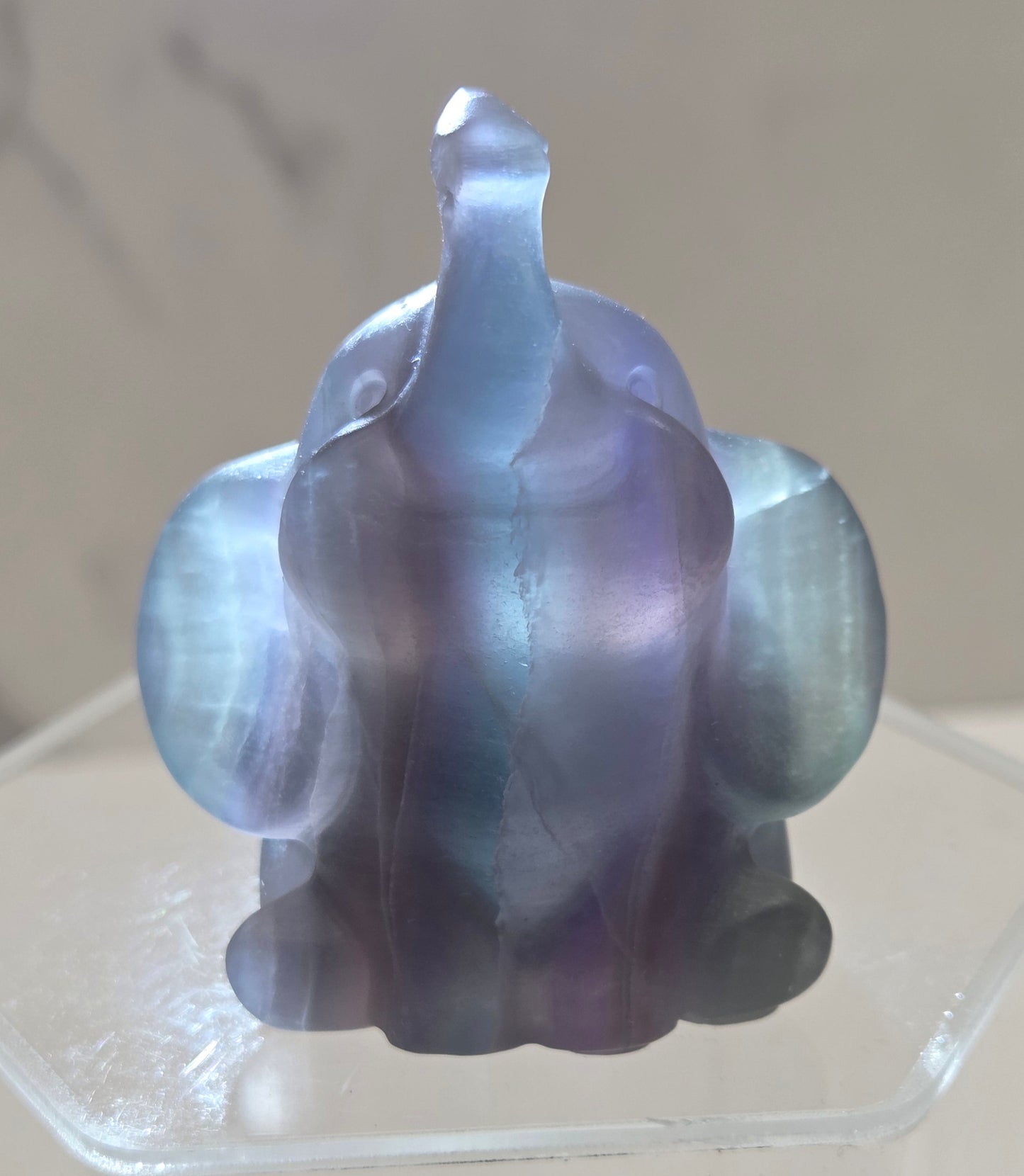 Decorative Fluorite sculpture backlit of an elephant on a white background