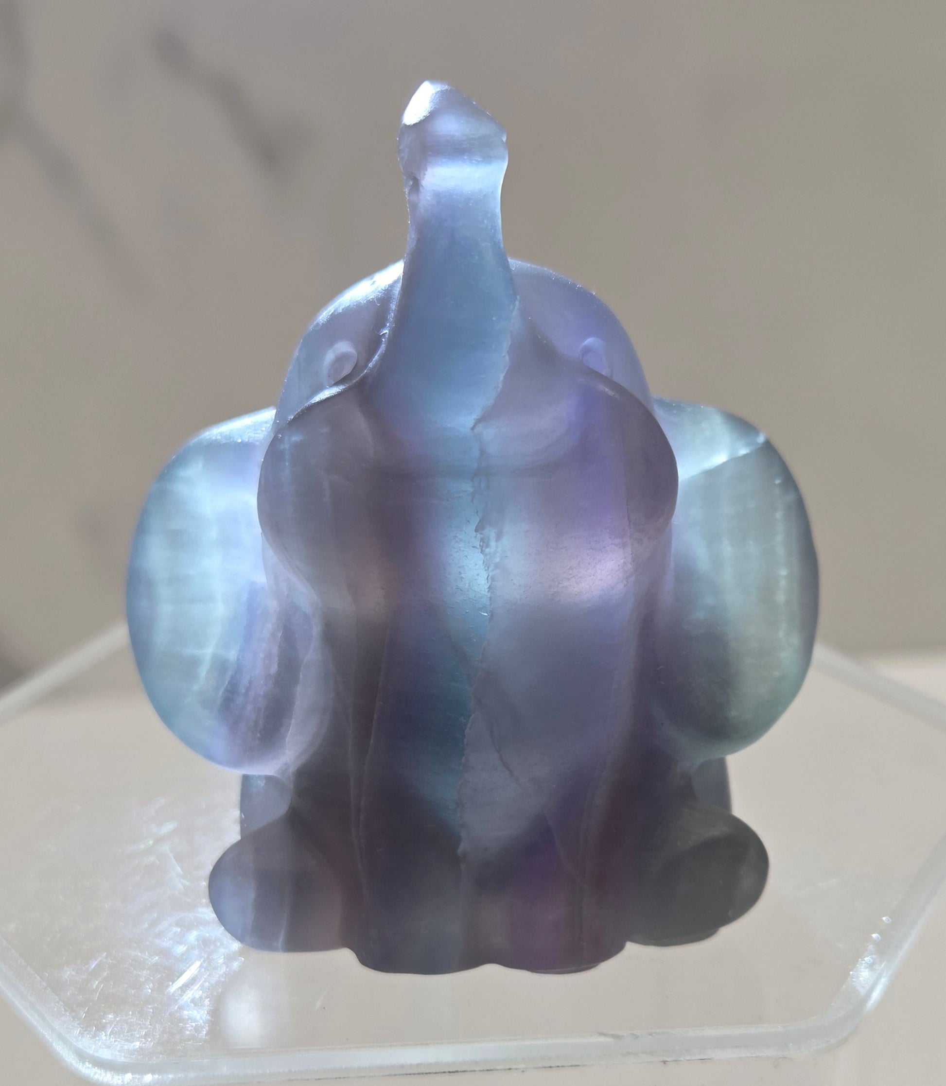 Decorative Fluorite sculpture backlit of an elephant on a white background