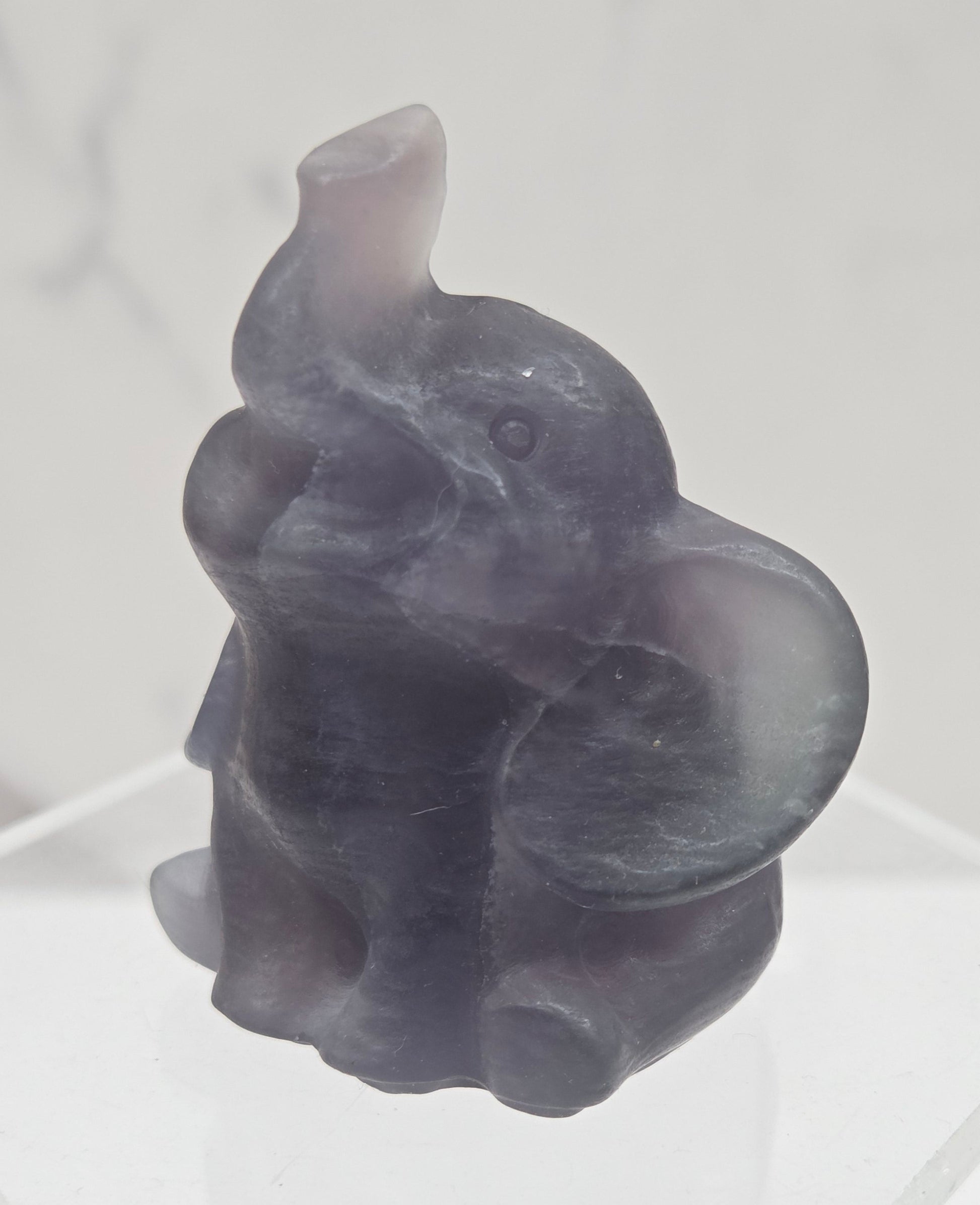 Decorative Fluorite sculpture of an elephant on a white background