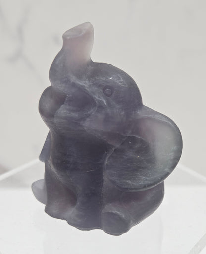 Decorative Fluorite sculpture of an elephant on a white background