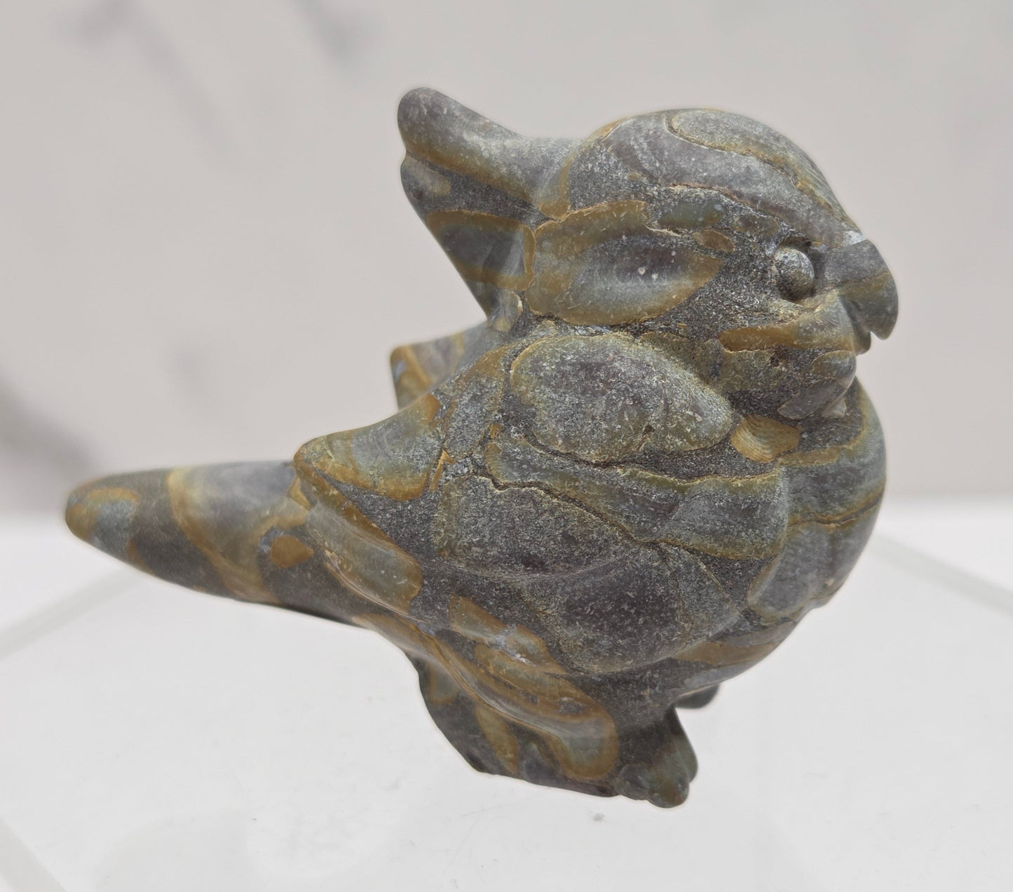 Decorative bird carving made of Bamboo Jasper on a white background