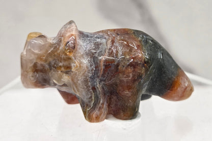 Crystal triceratops figurine on a white background