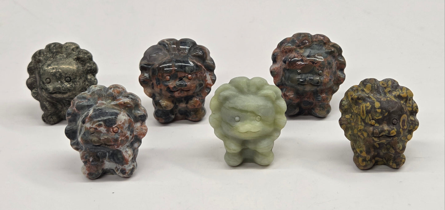 Five stone lion carvings on a white background