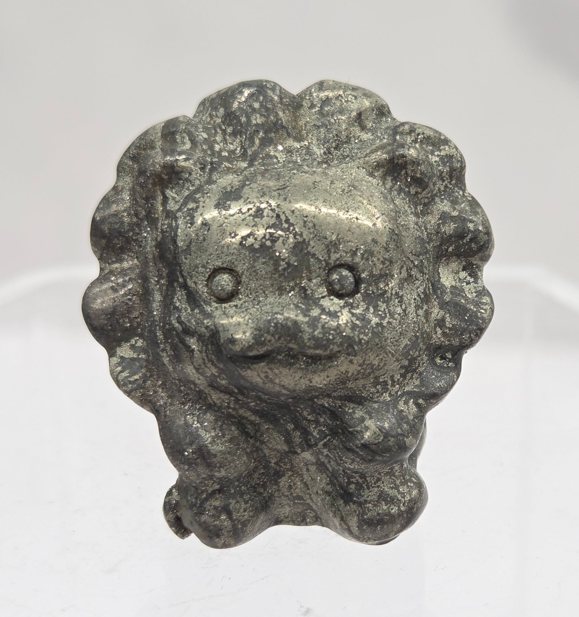 Pyrite lion carving on a white background