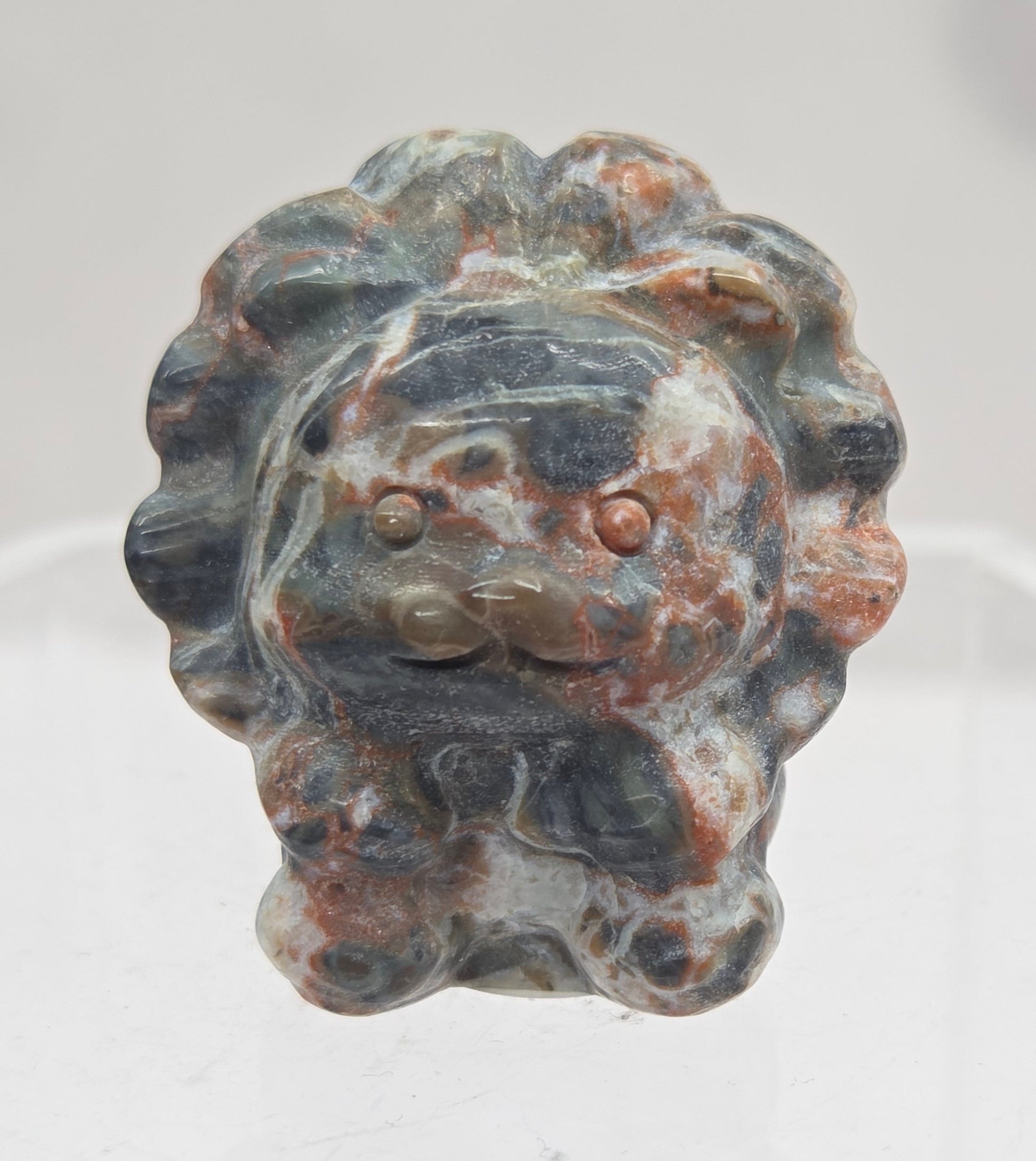 Money Agate lion carving on a white background