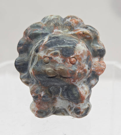 Money Agate lion carving on a white background