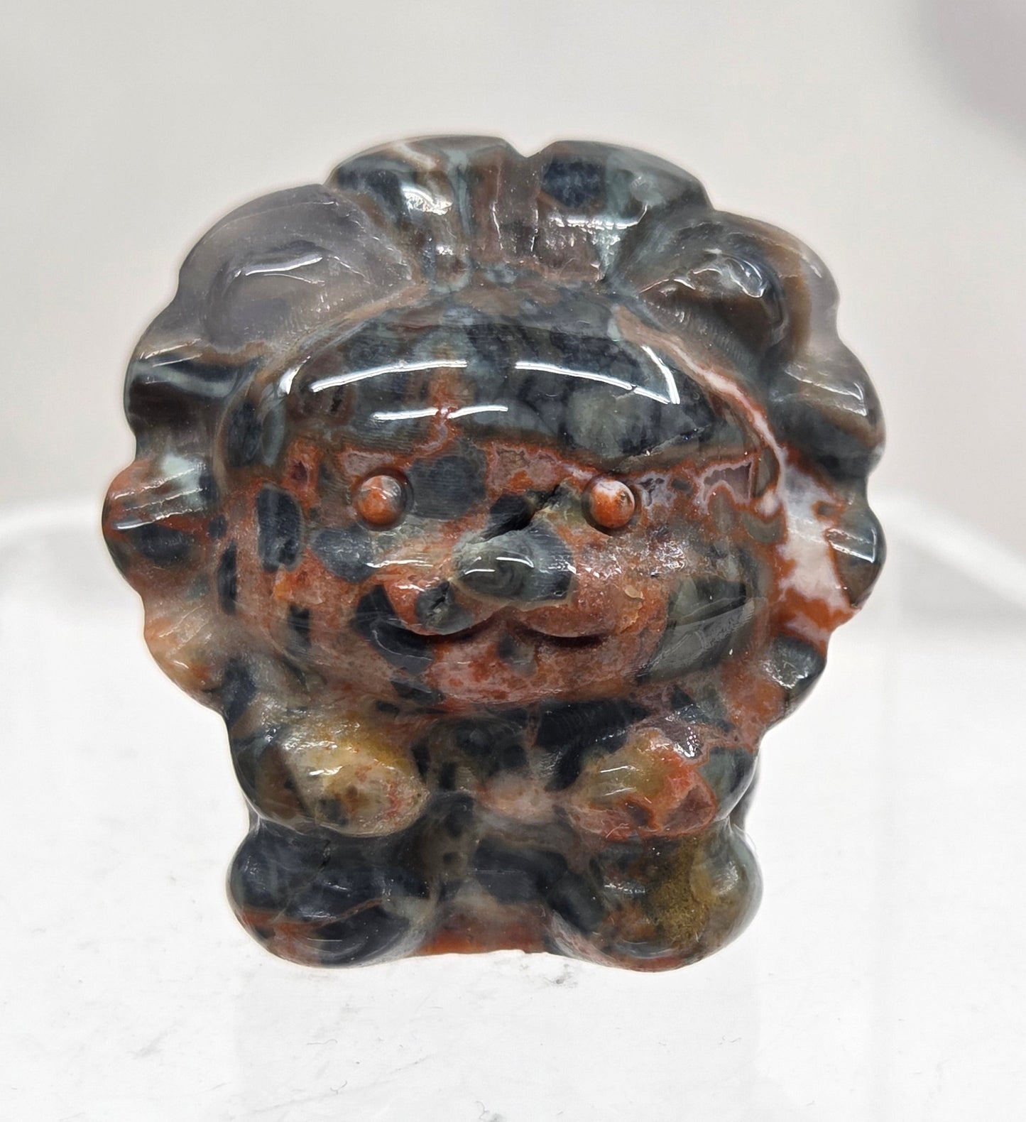 Money Agate lion carving on a white background