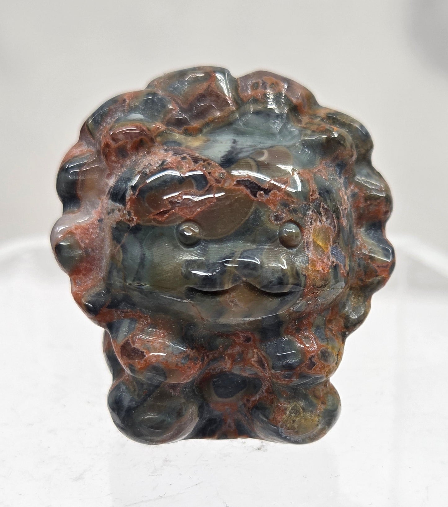 Money Agate lion carving on a white background