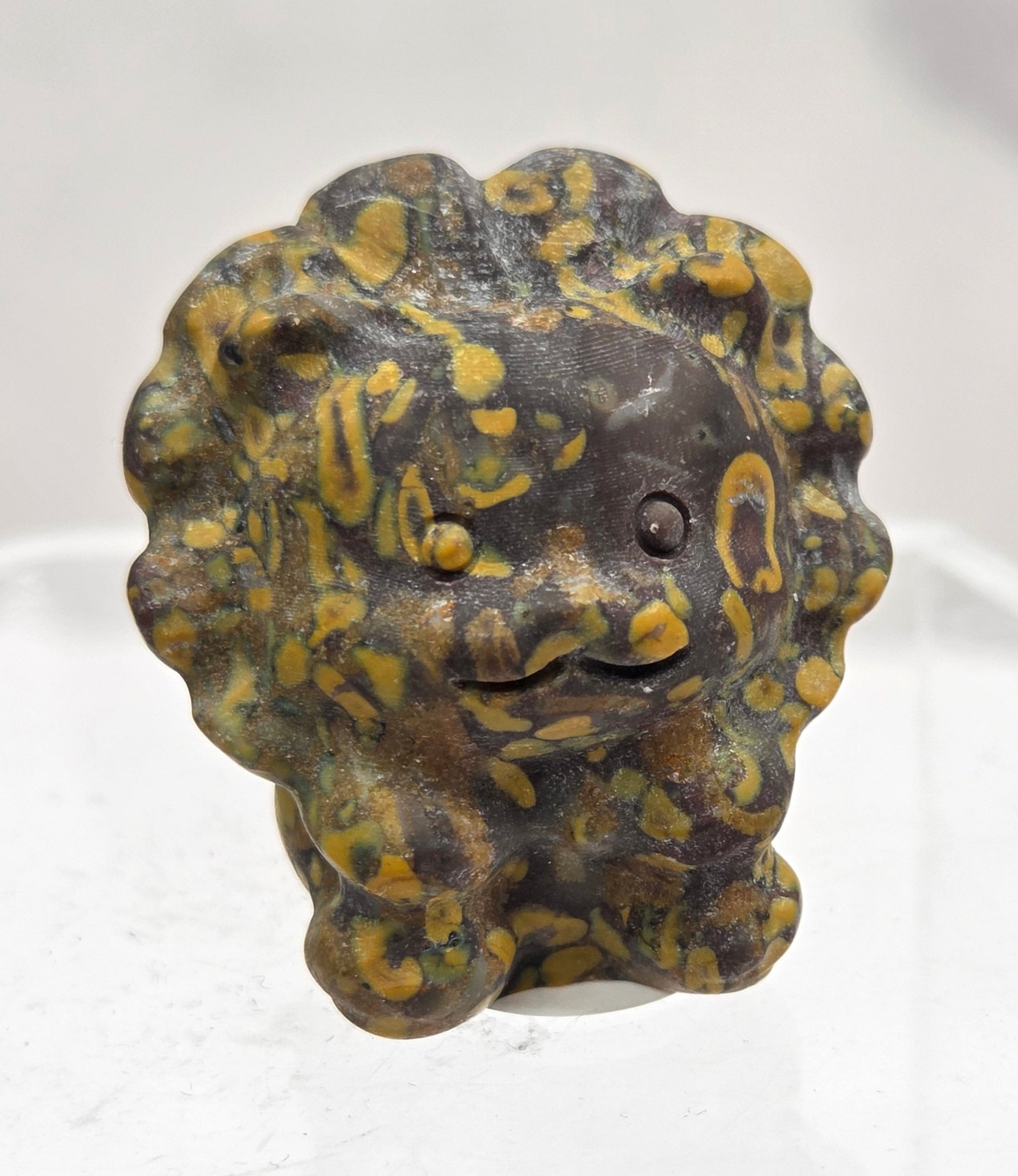 Ajooba Jasper lion carving on a white background