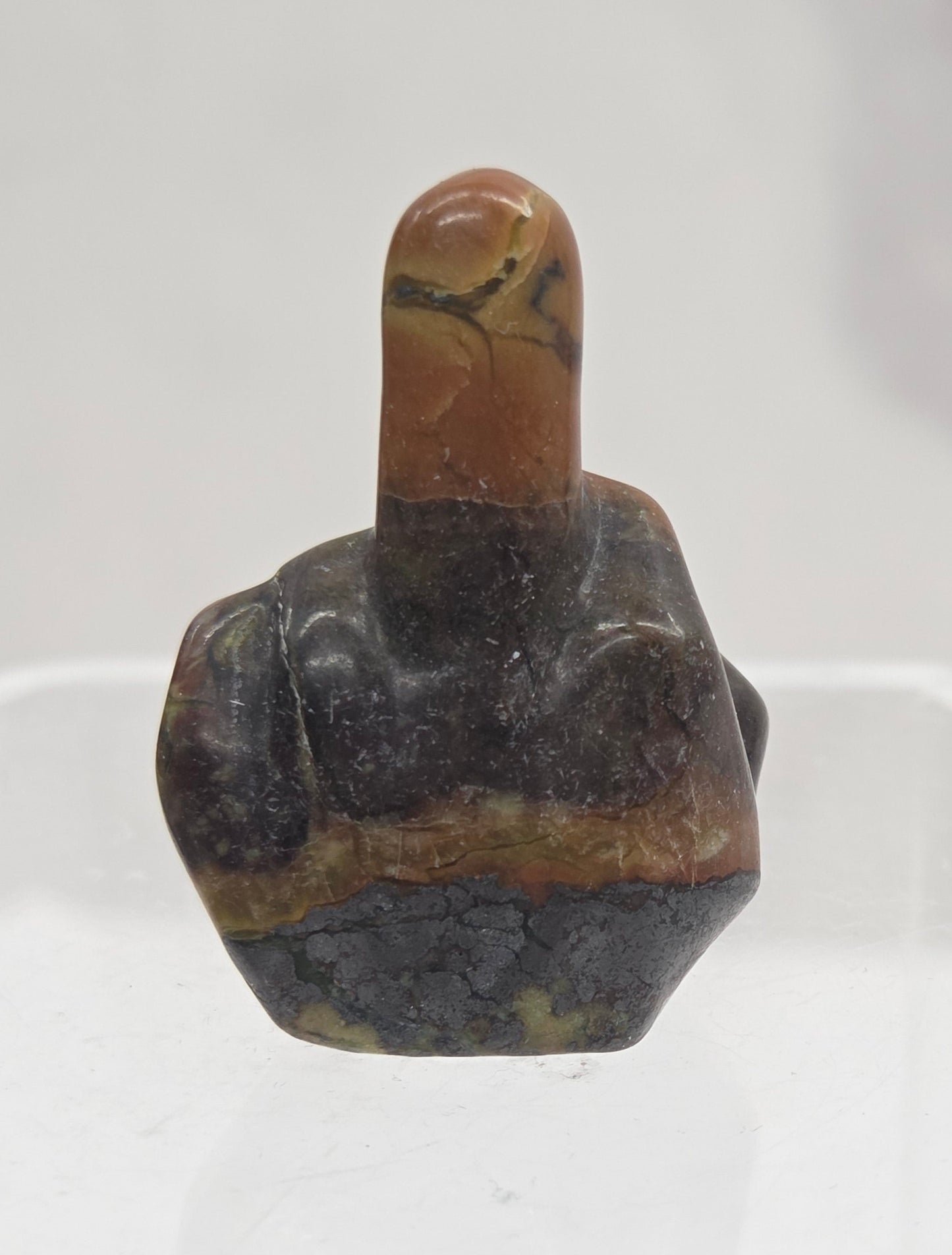 A Jasper carving of a middle finger gesture.