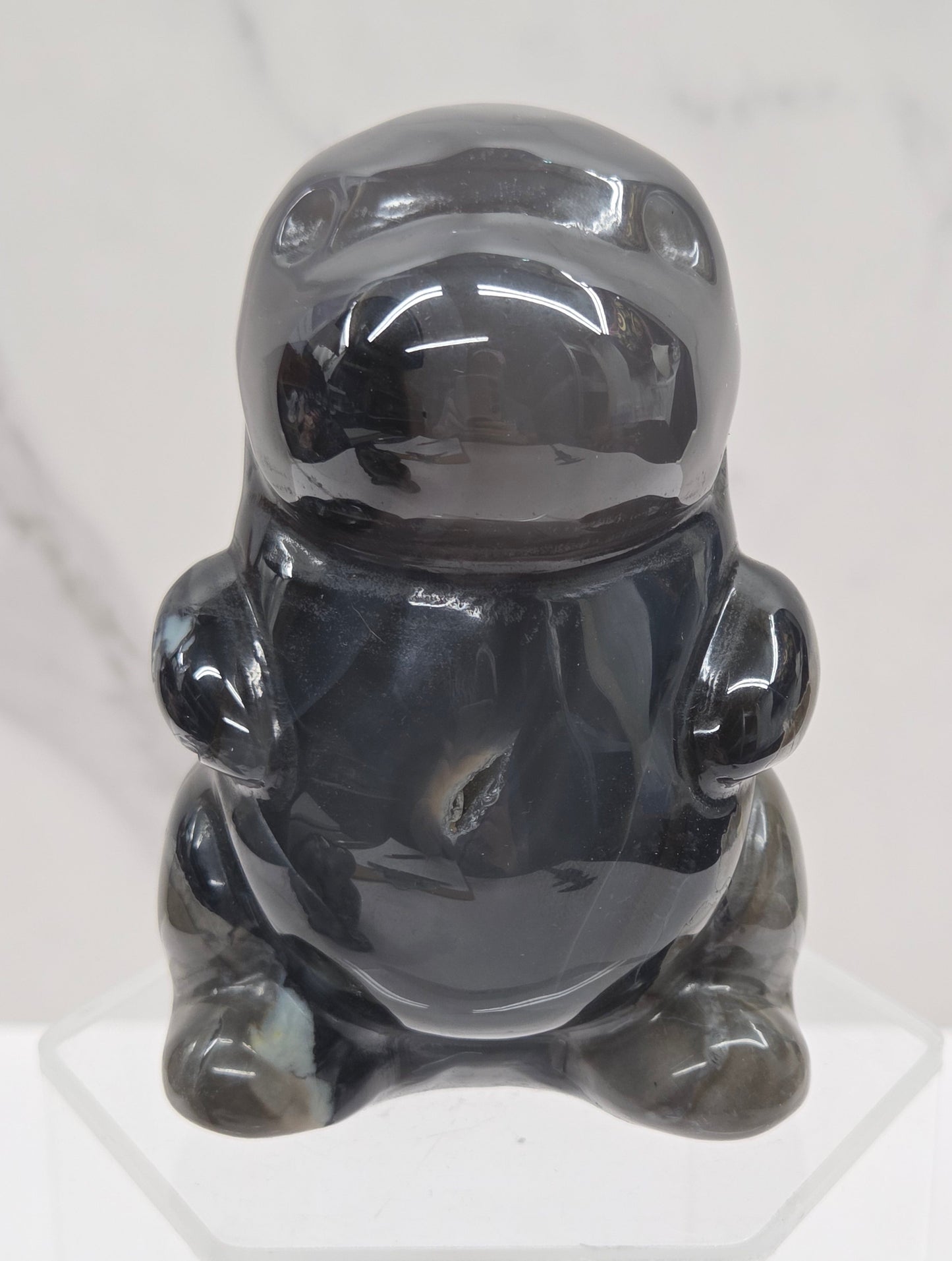 Volcano Agate cute dinosaur like carving on a white background