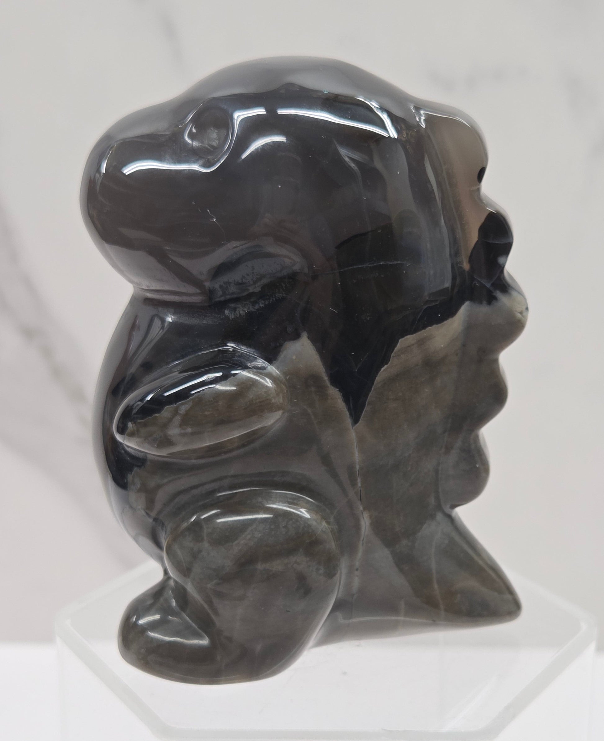 Volcano Agate cute dinosaur like carving on a white background