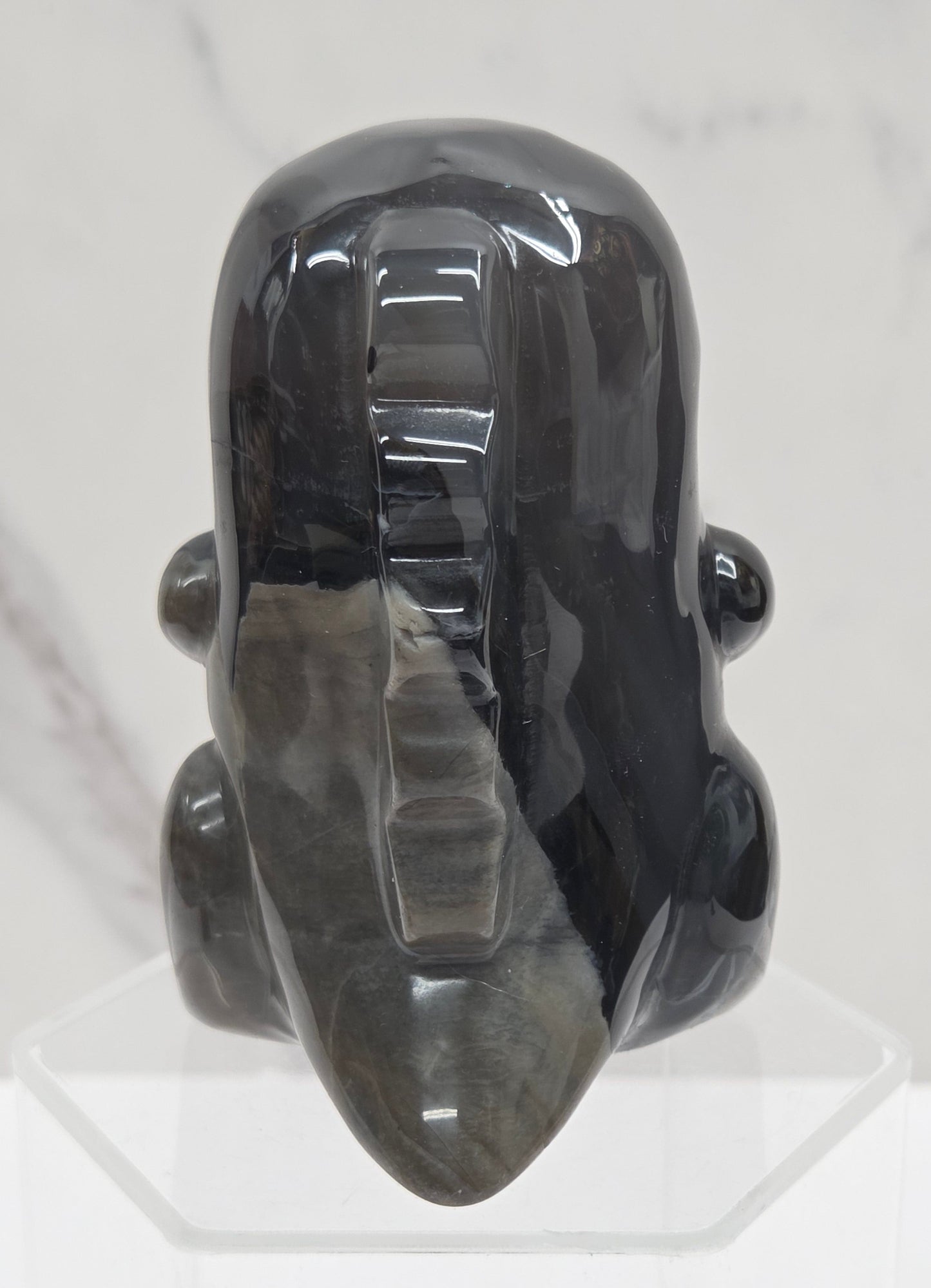 Volcano Agate cute dinosaur like carving on a white background