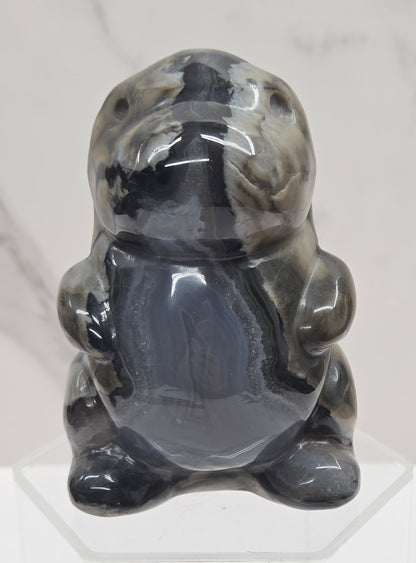 Volcano Agate cute dinosaur like carving on a white background