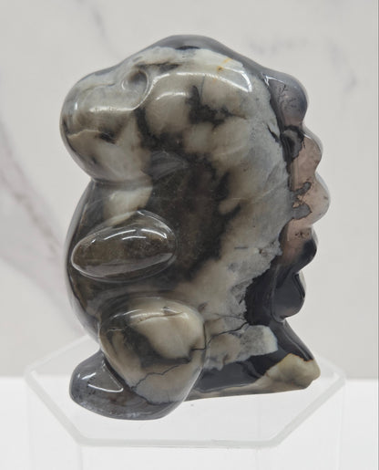 Volcano Agate cute dinosaur like carving on a white background