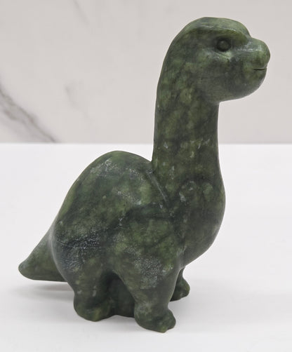Decorative Green Jade dinosaur carving on a white background