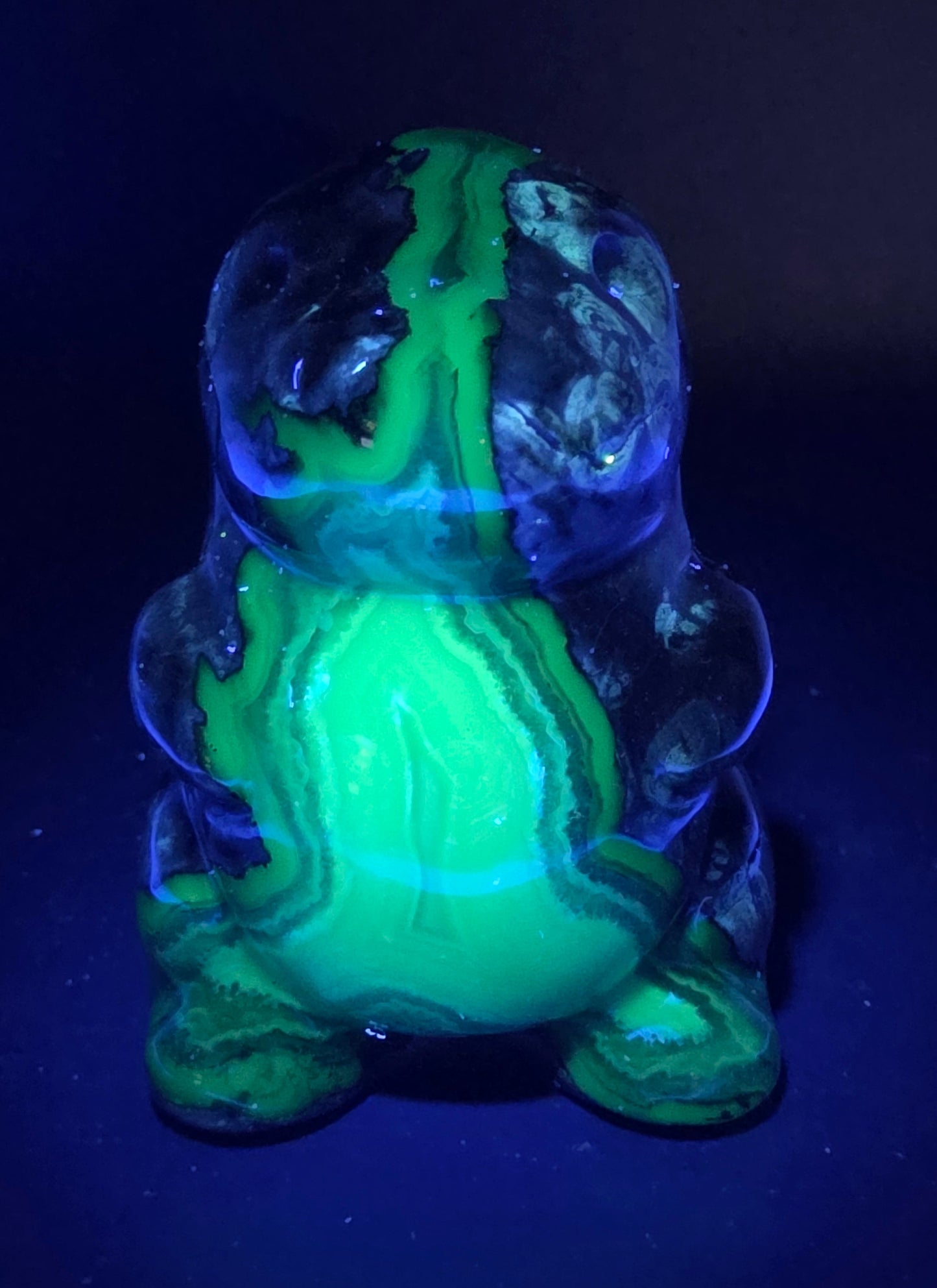 Volcano Agate cute dinosaur like carving under UV light