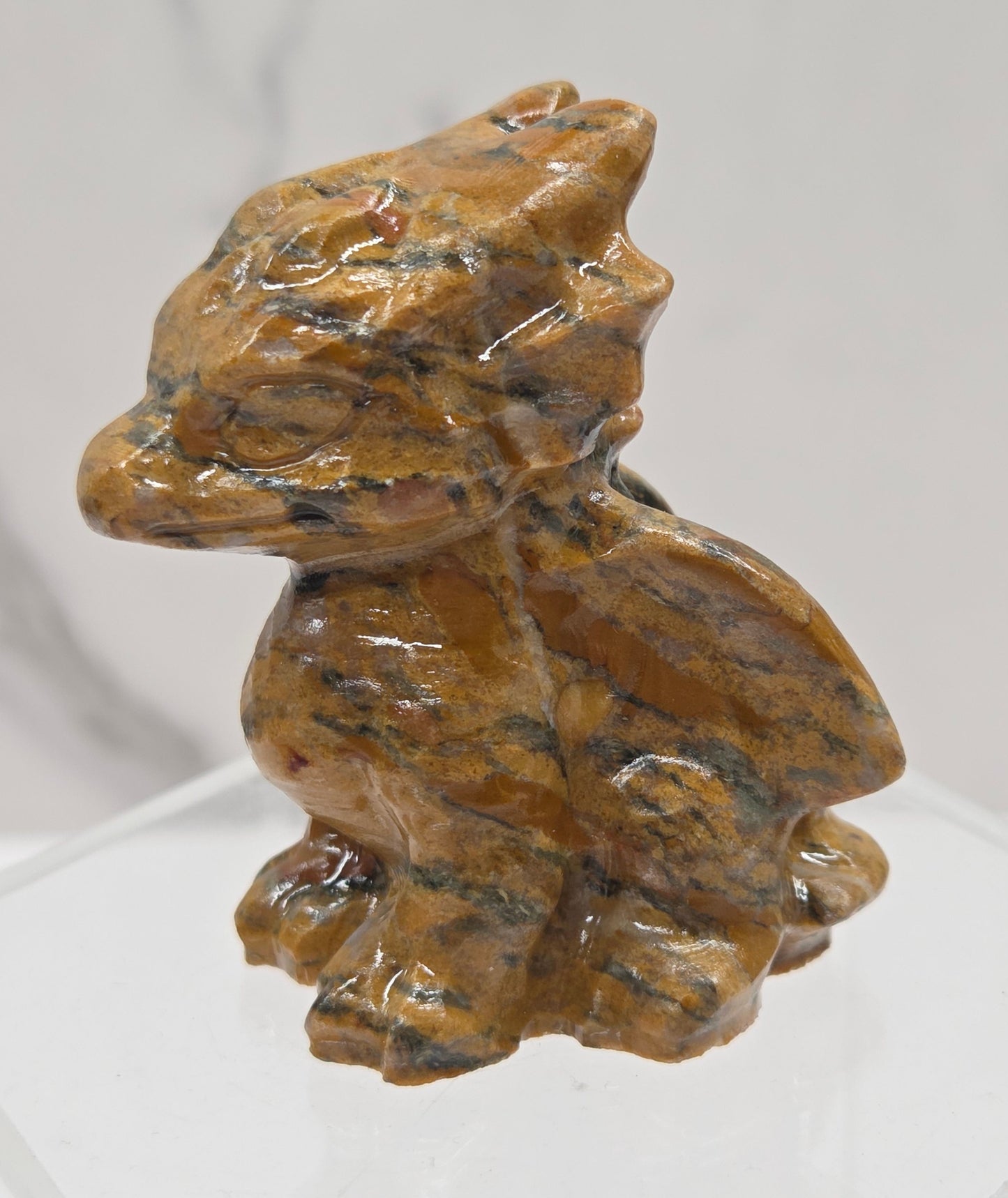 Tiger Jasper crystal dragon carving on a white background