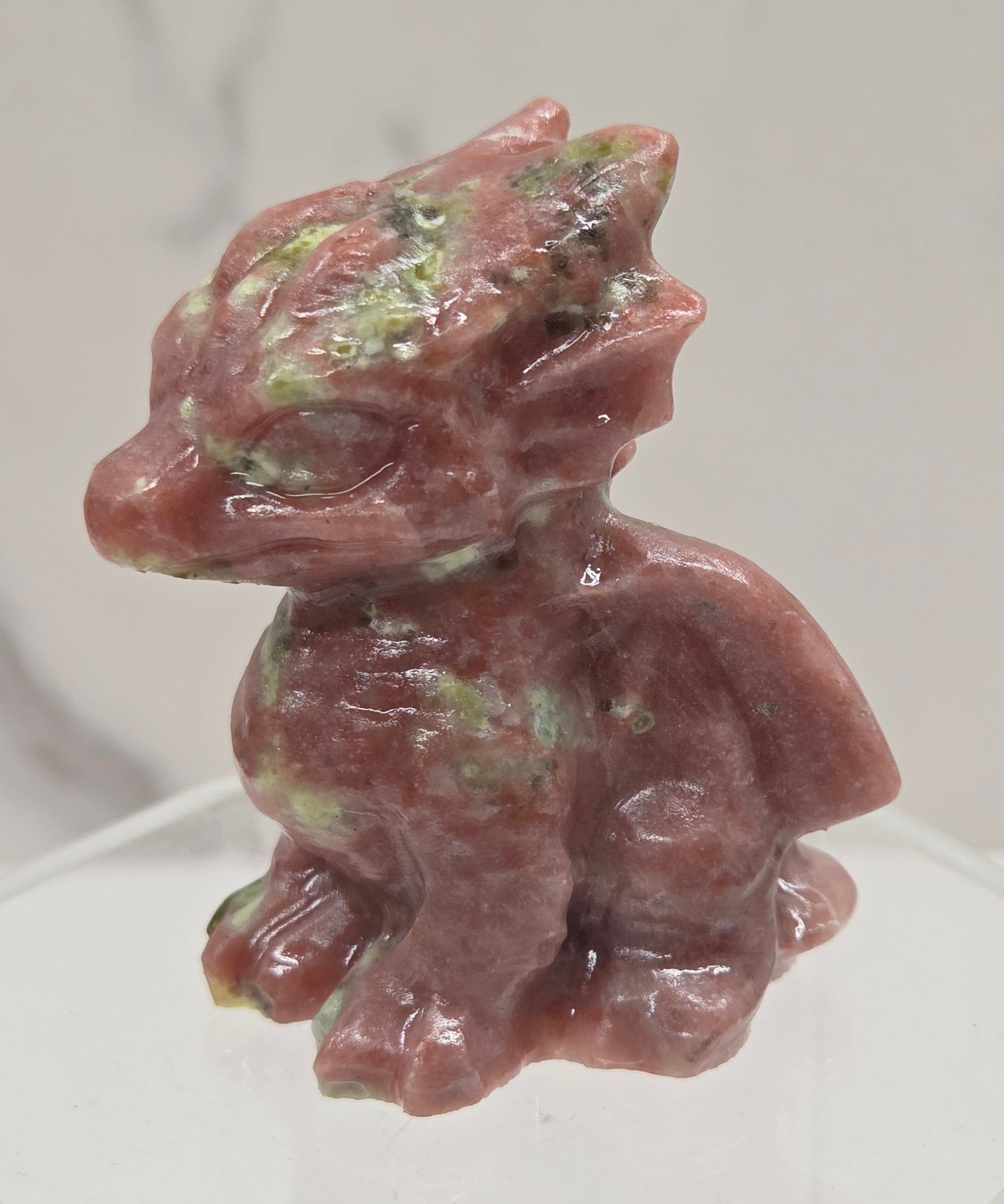 Red Serpentine crystal dragon carving on a white background