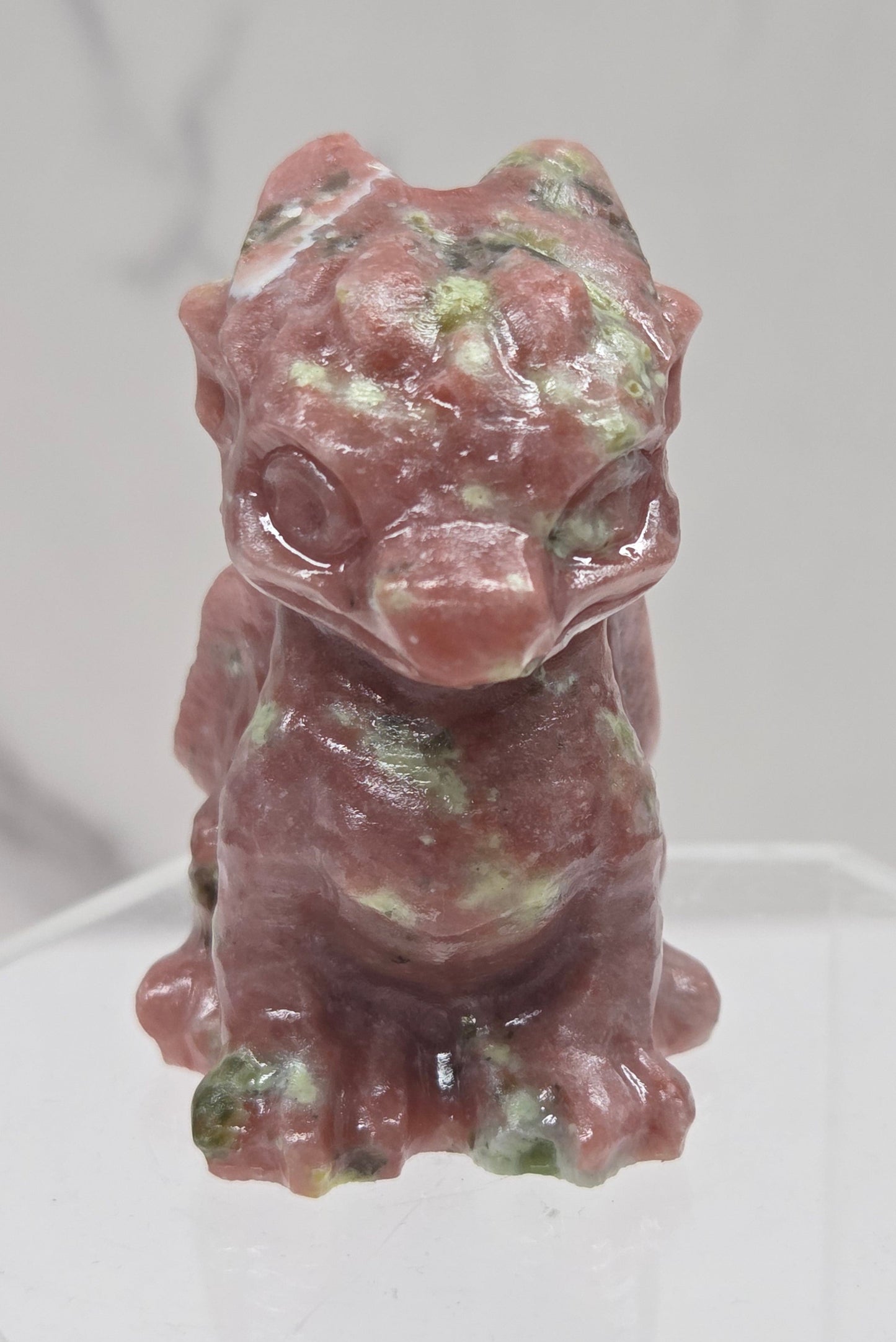 Red Serpentine crystal dragon carving on a white background