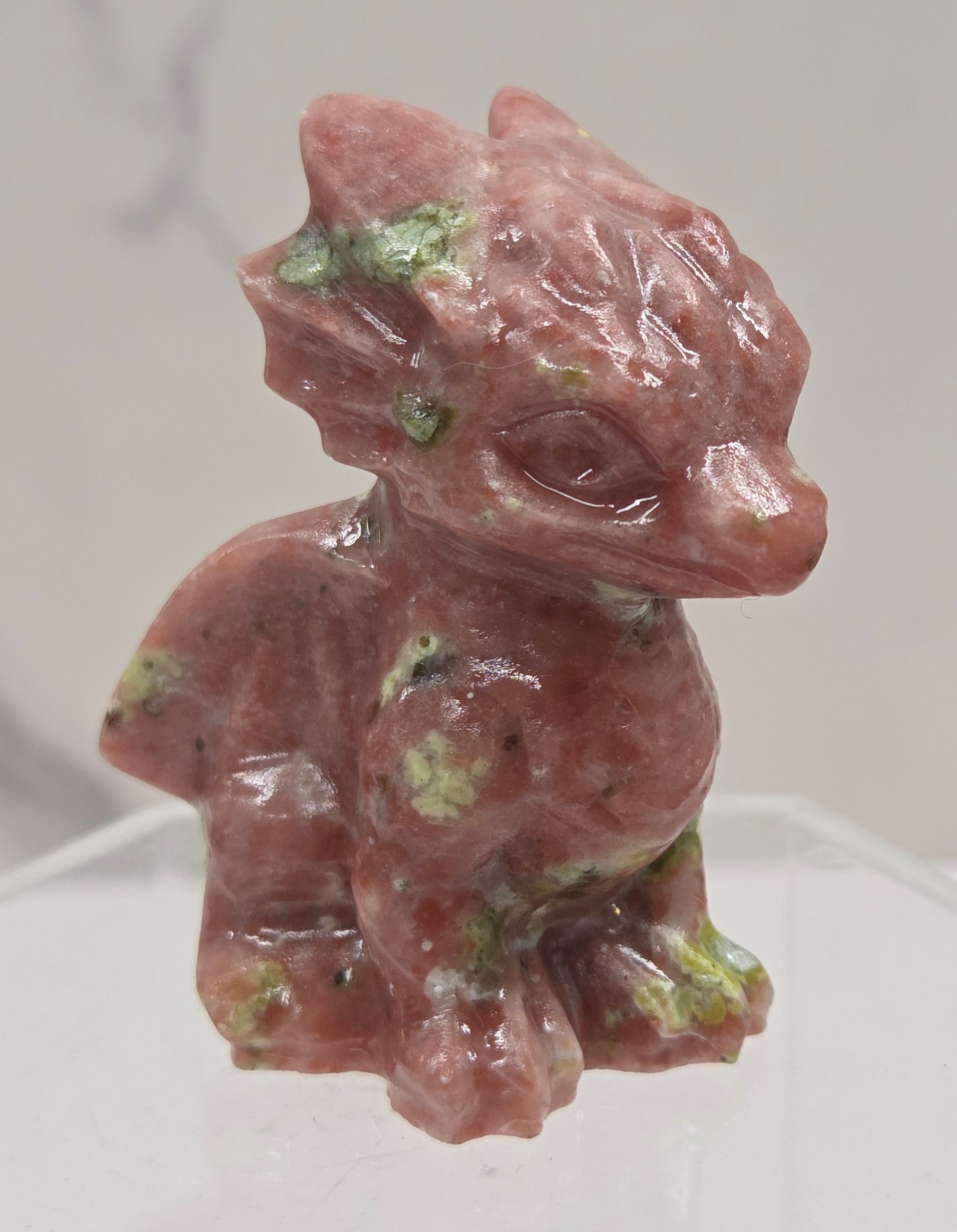Red Serpentine crystal dragon carving on a white background