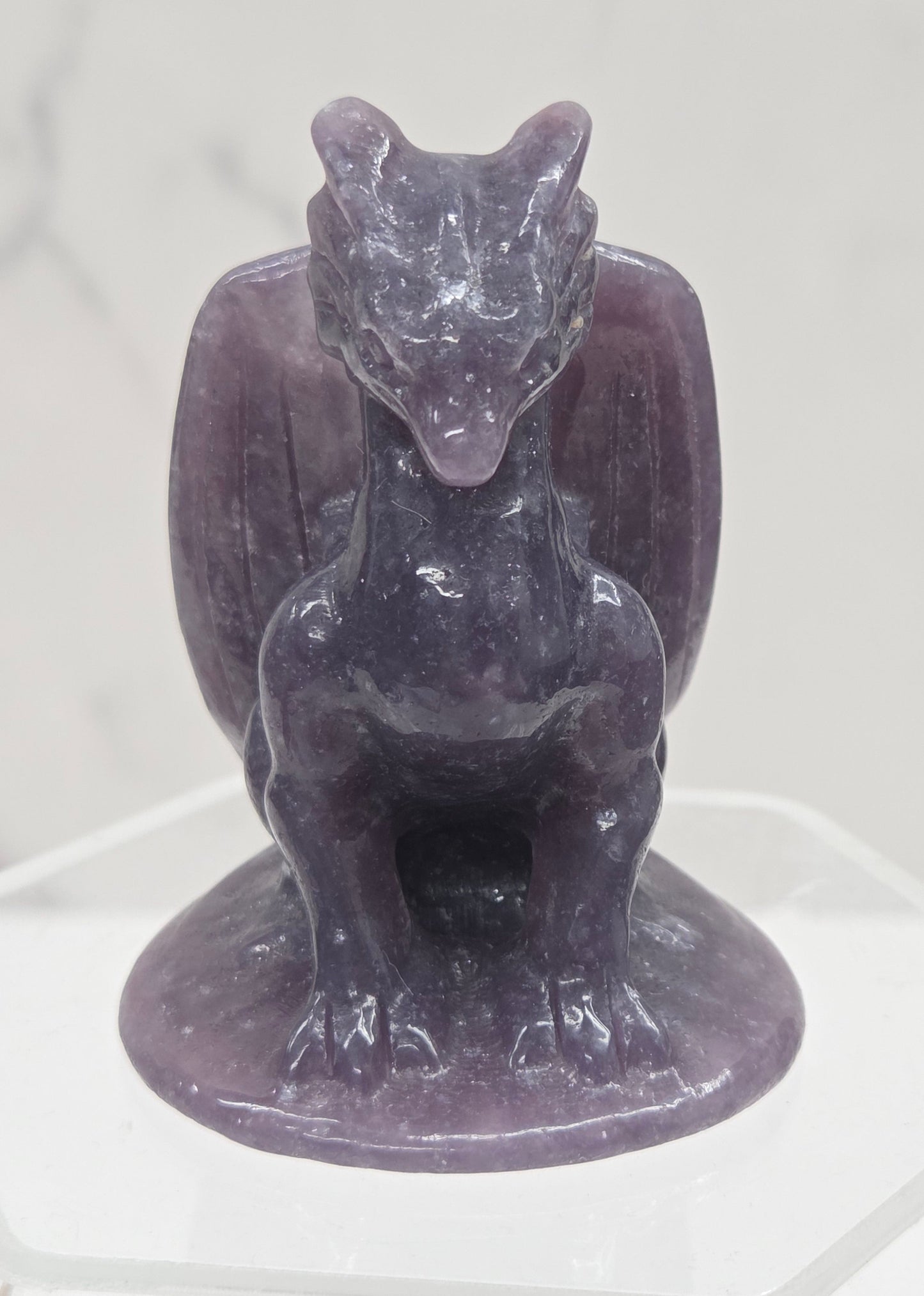Lepidolite crystal dragon sculpture on a white background