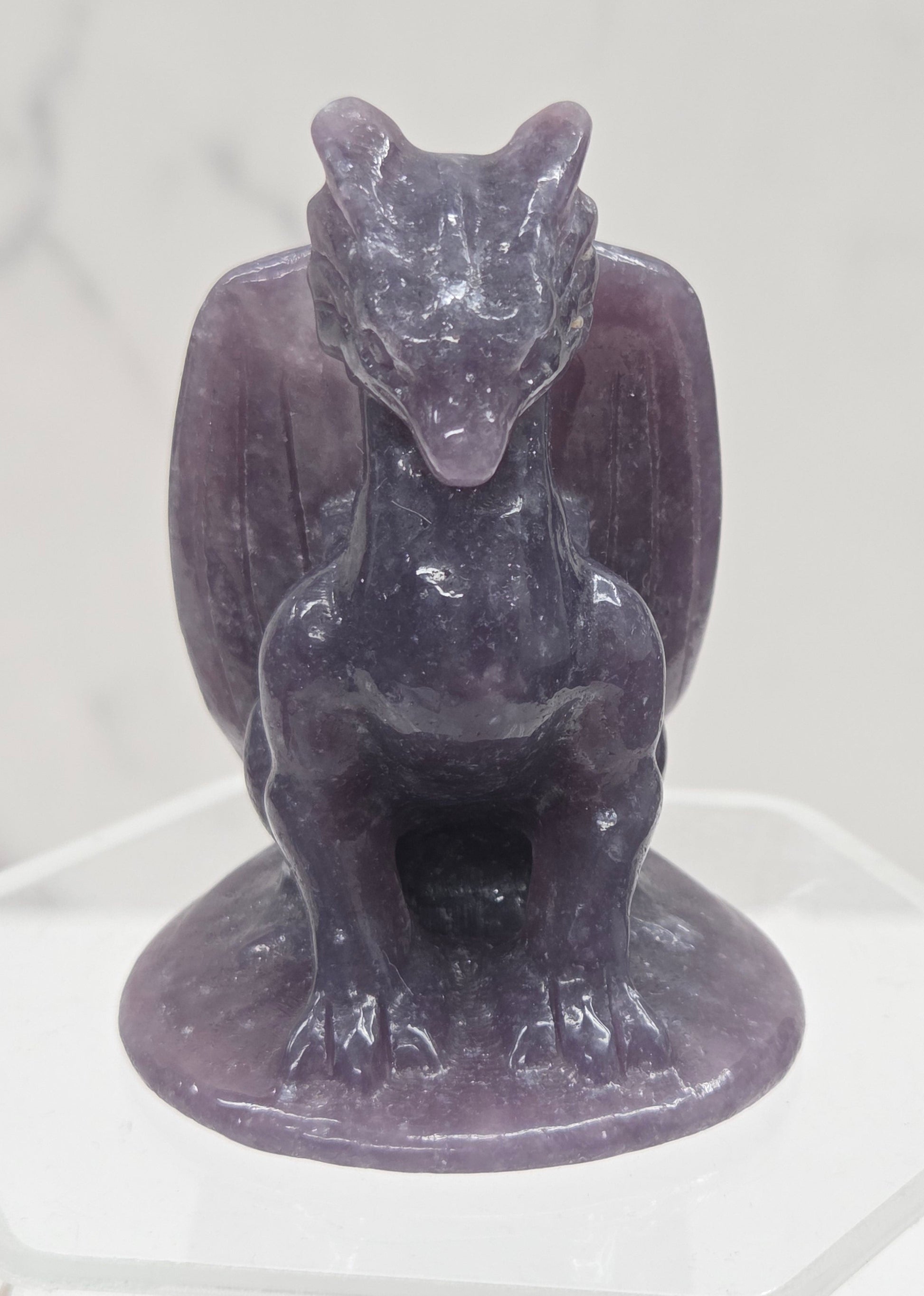 Lepidolite crystal dragon sculpture on a white background