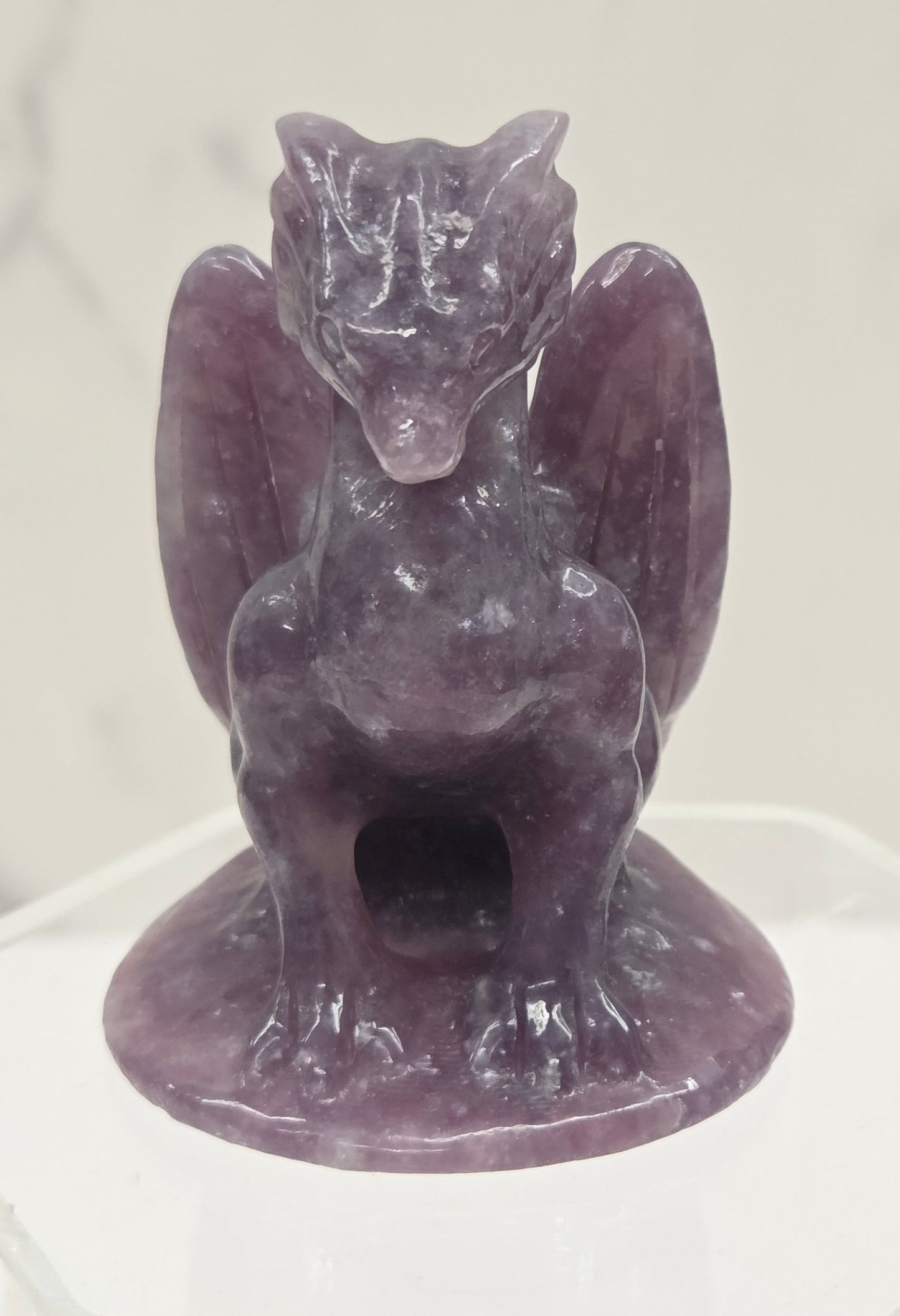 Lepidolite crystal dragon sculpture on a white background