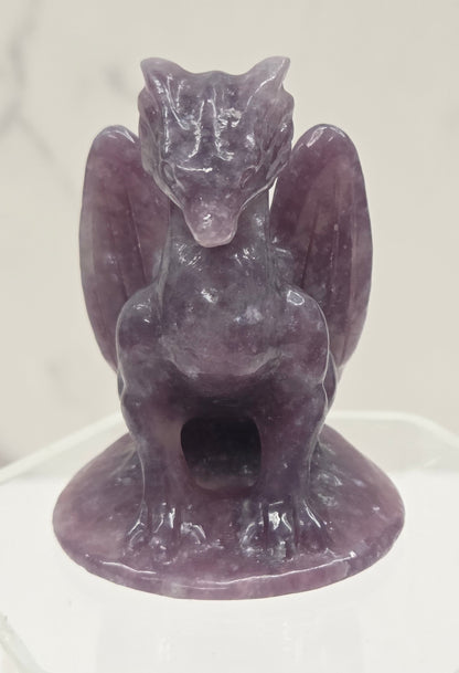 Lepidolite crystal dragon sculpture on a white background