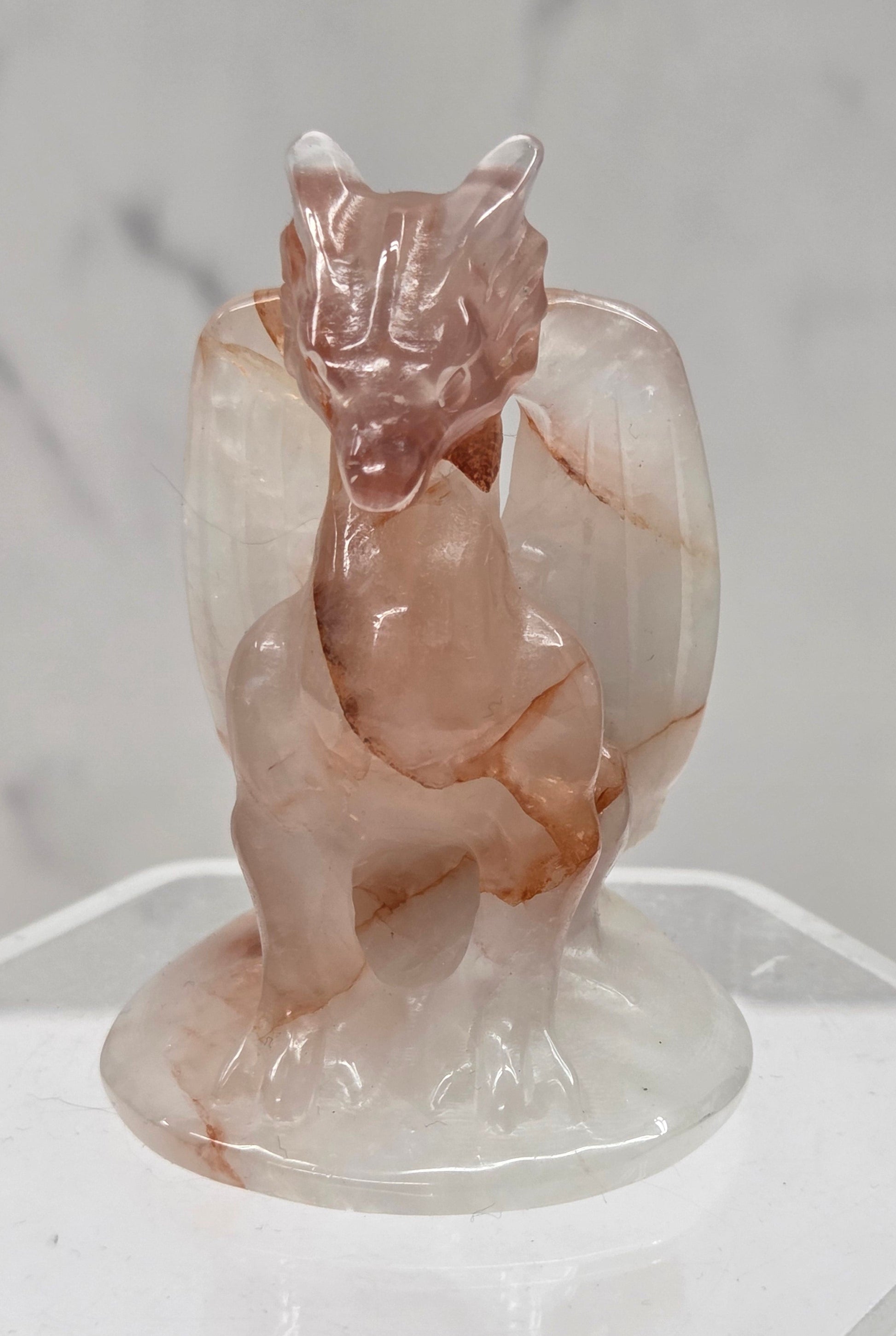 Fire Quartz crystal dragon sculpture on a white background