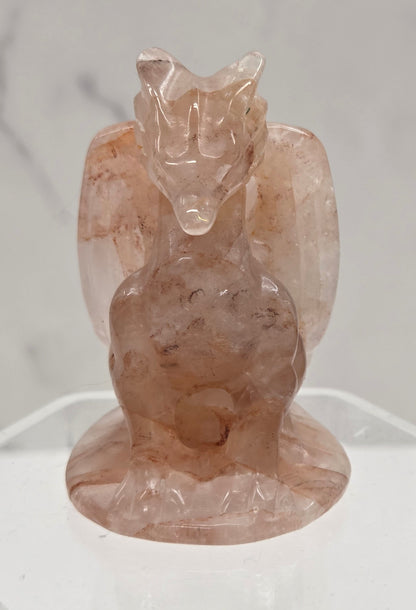 Fire Quartz crystal dragon sculpture on a white background