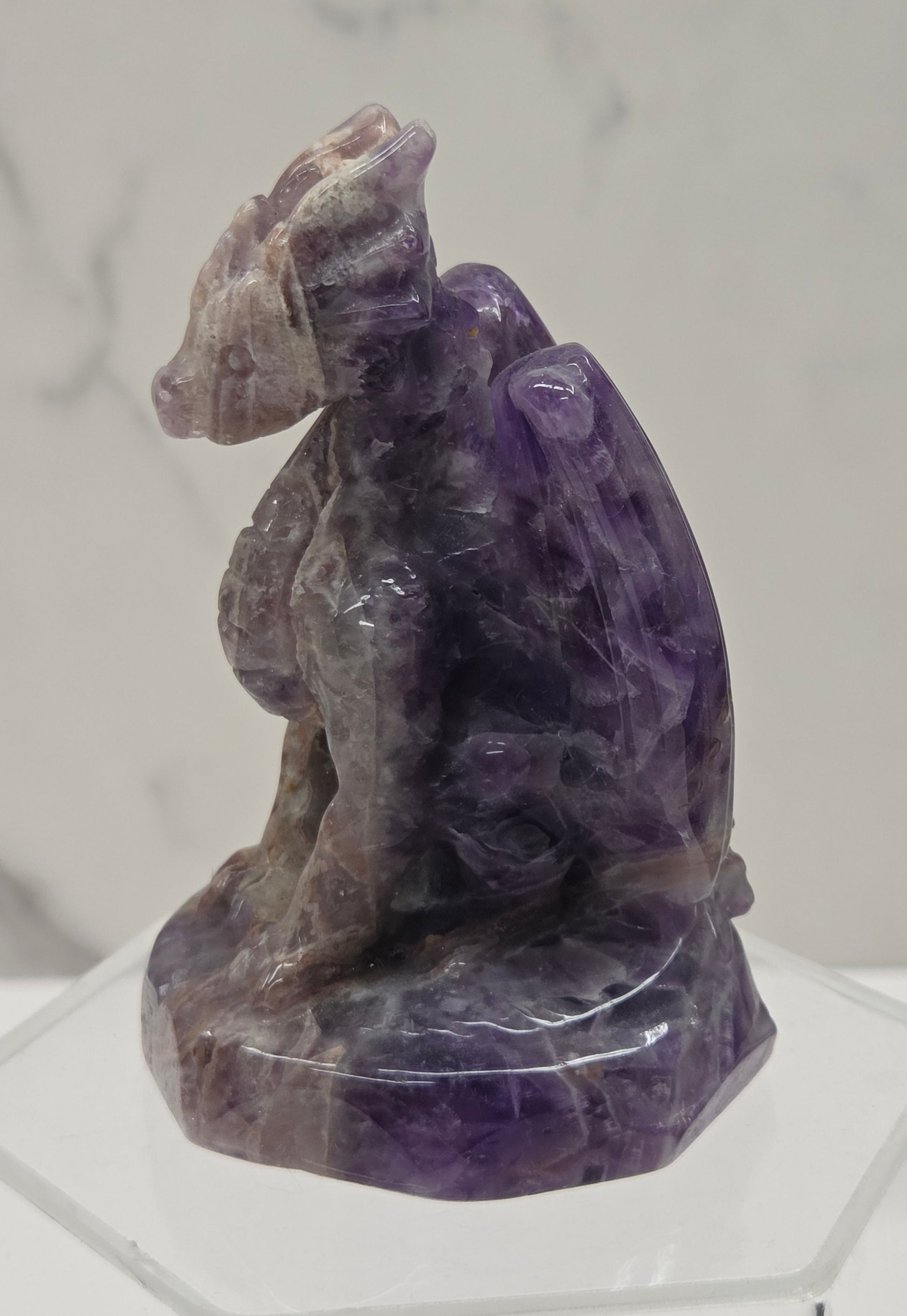 Dream Amethyst crystal dragon sculpture on a white background