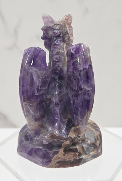 Dream Amethyst crystal dragon sculpture on a white background