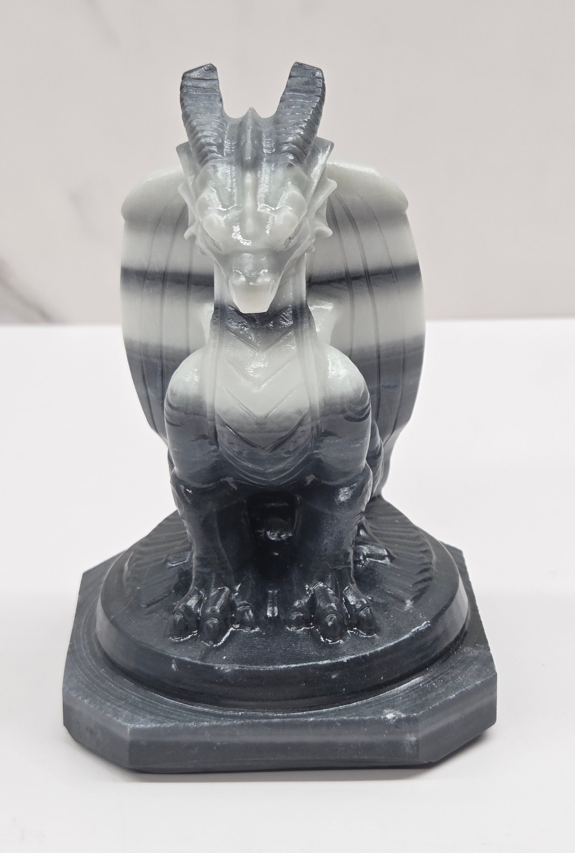 Tai Chi Jasper crystal dragon sculpture on a white background
