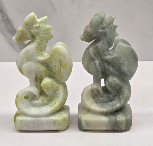 Set of 2 crystal dragon sculptures, one Lime Jade, one Blue Calcite, on a white background