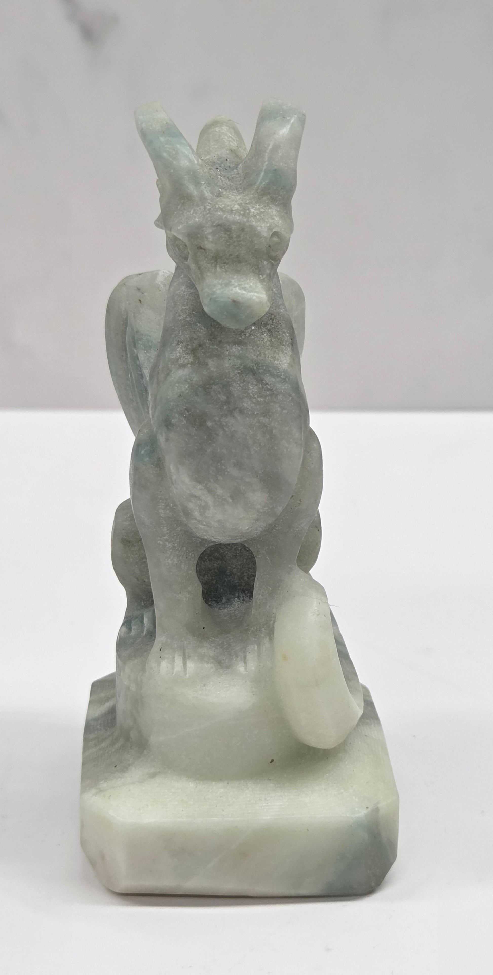 Blue Calcite crystal dragon sculpture on a white background