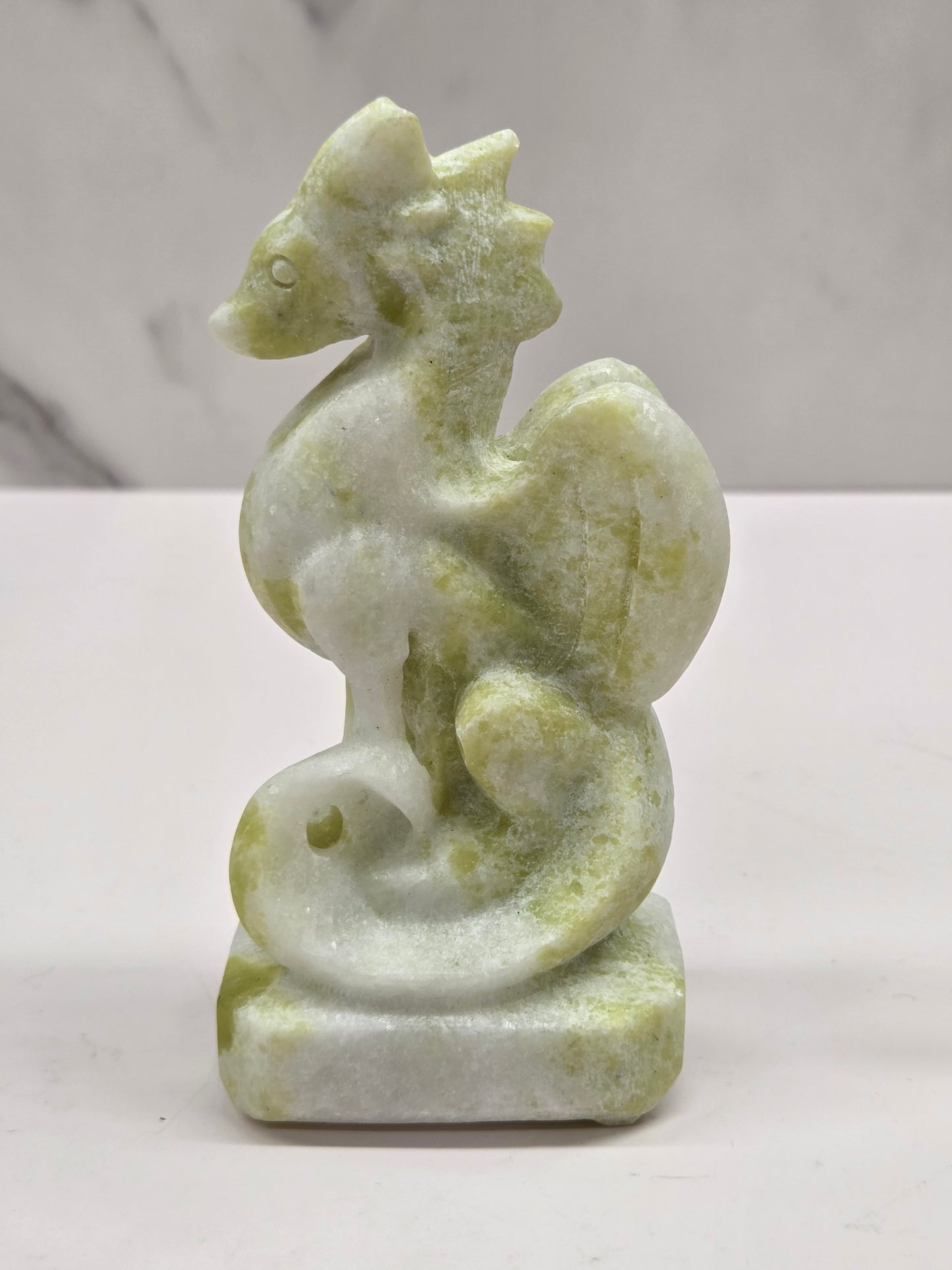 Lemon Jade crystal dragon sculpture on a white background