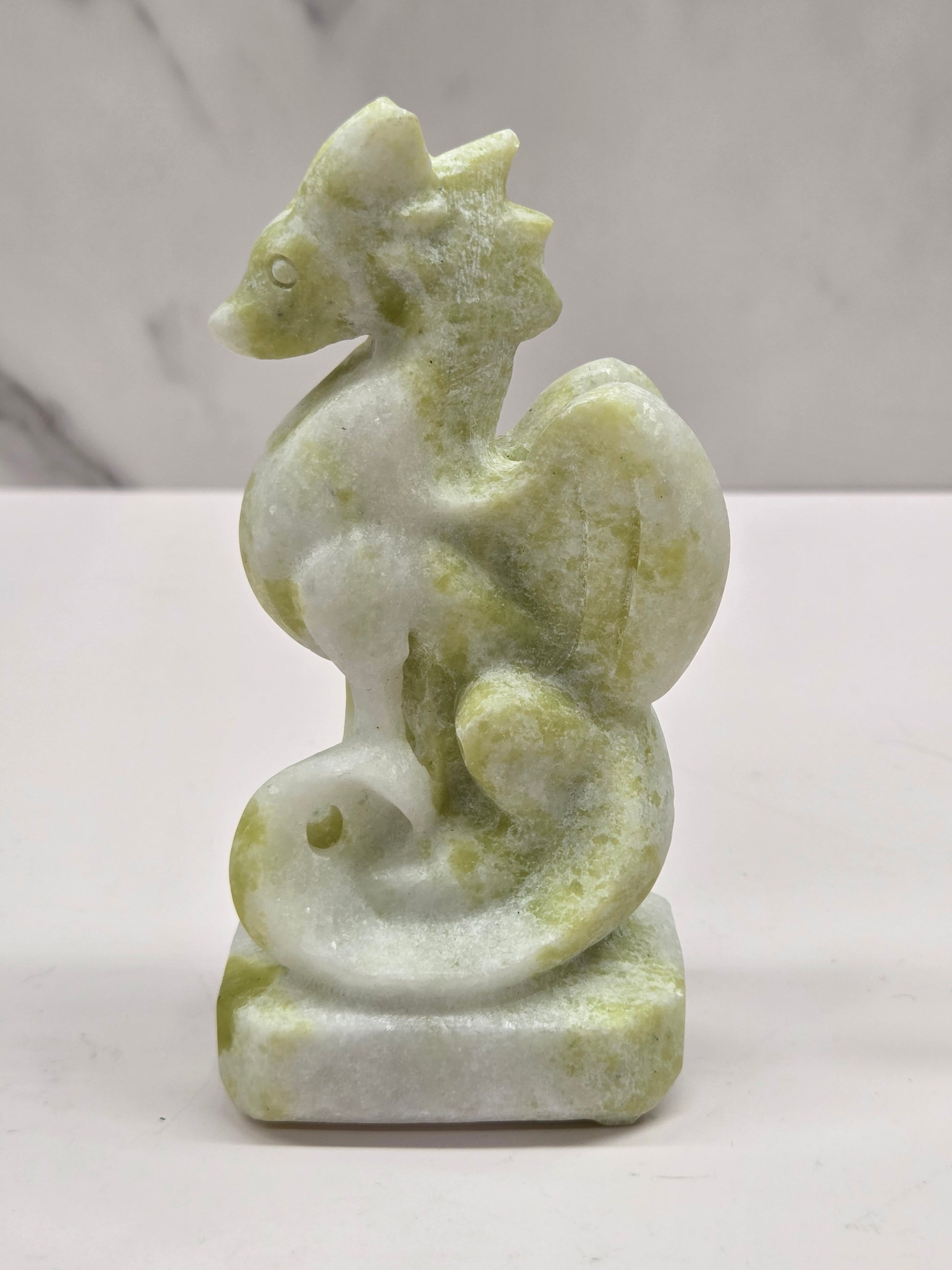 Lemon Jade crystal dragon sculpture on a white background