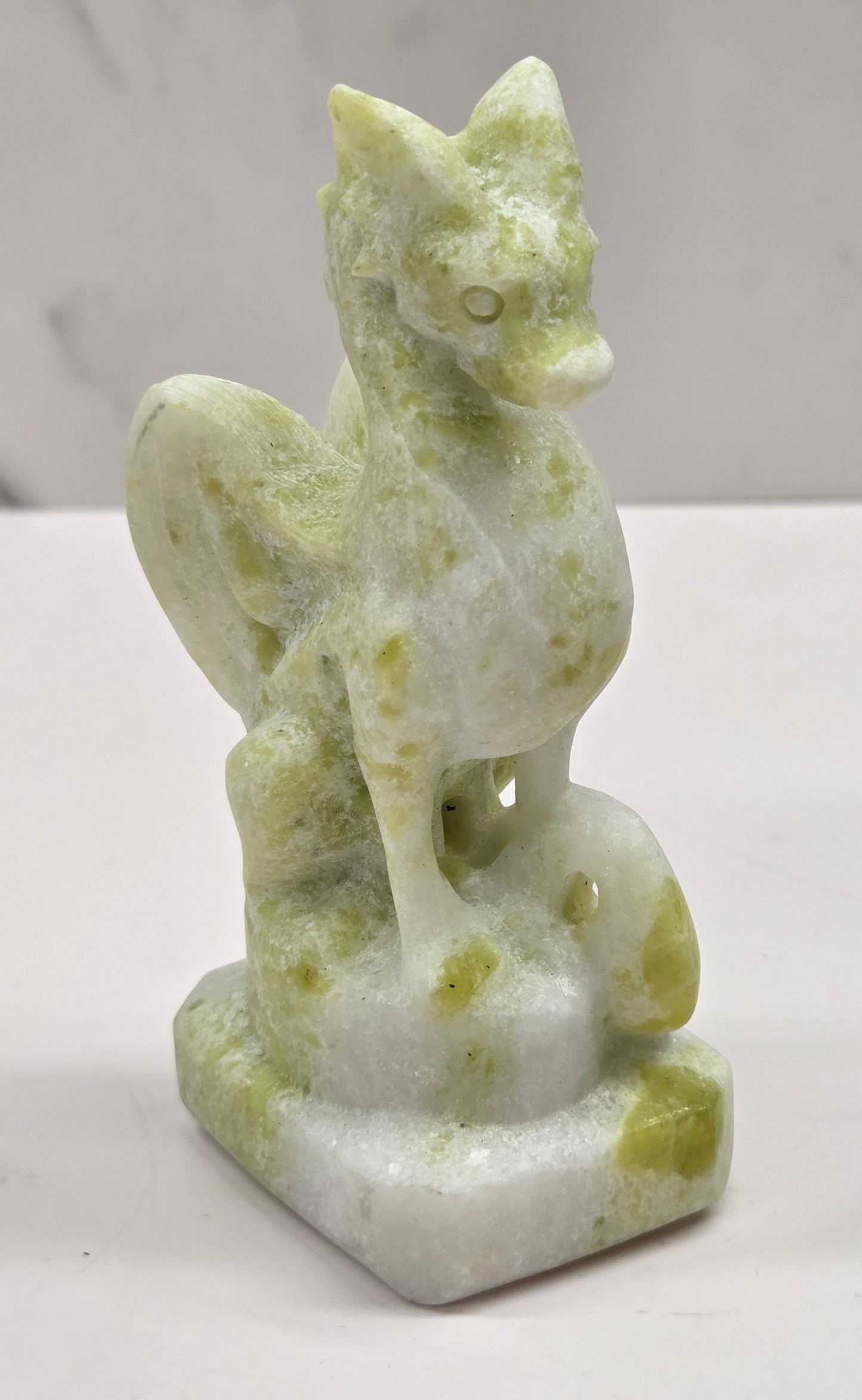 Lemon Jade crystal dragon sculpture on a white background