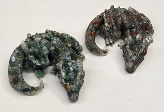 Two resin with crystal chip carvings of dragons on a white background