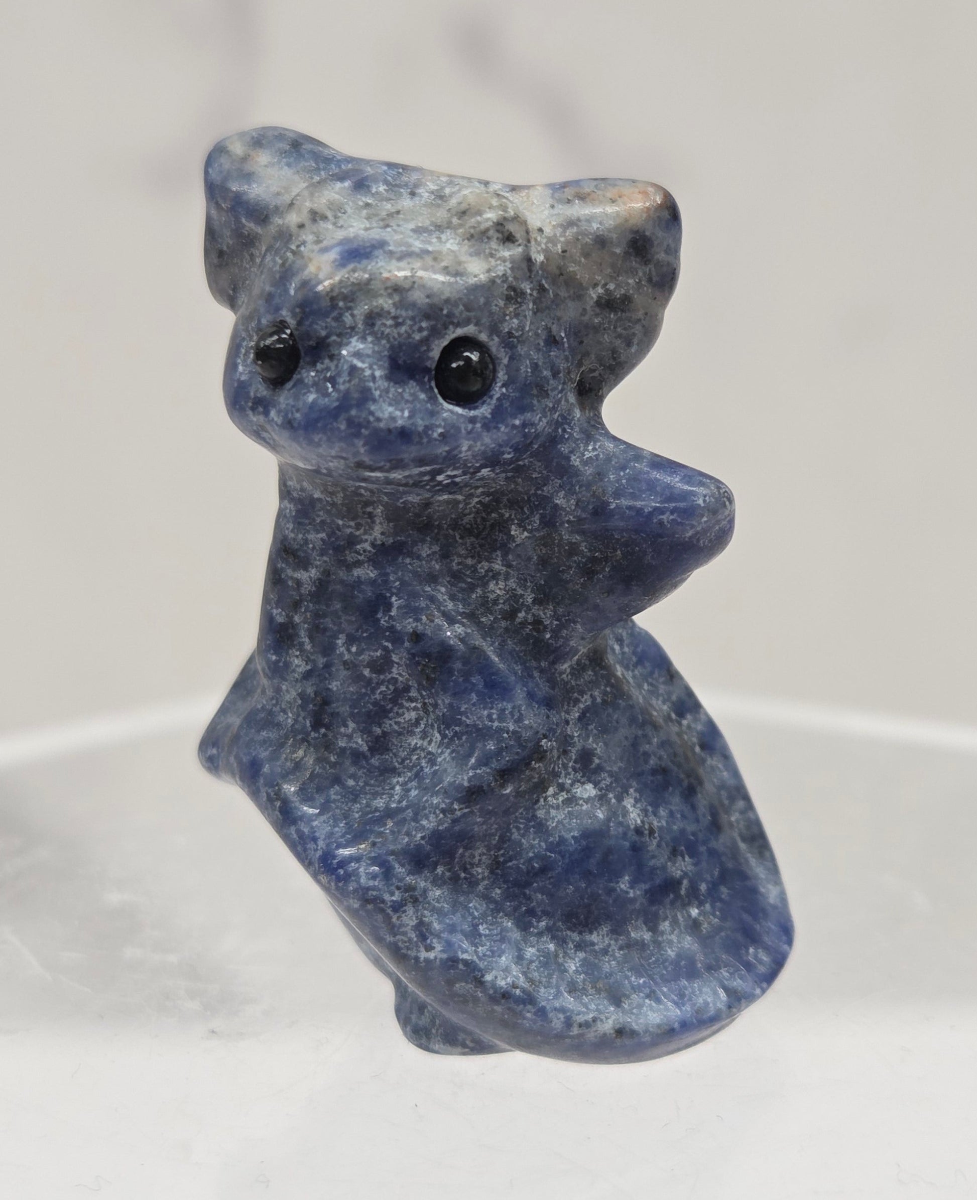 Sodalite dragon carving on a white background