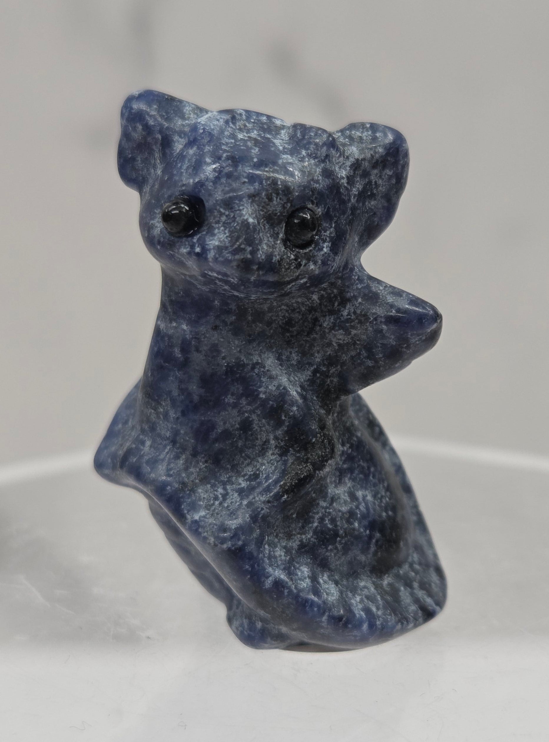 Sodalite dragon carving on a white background