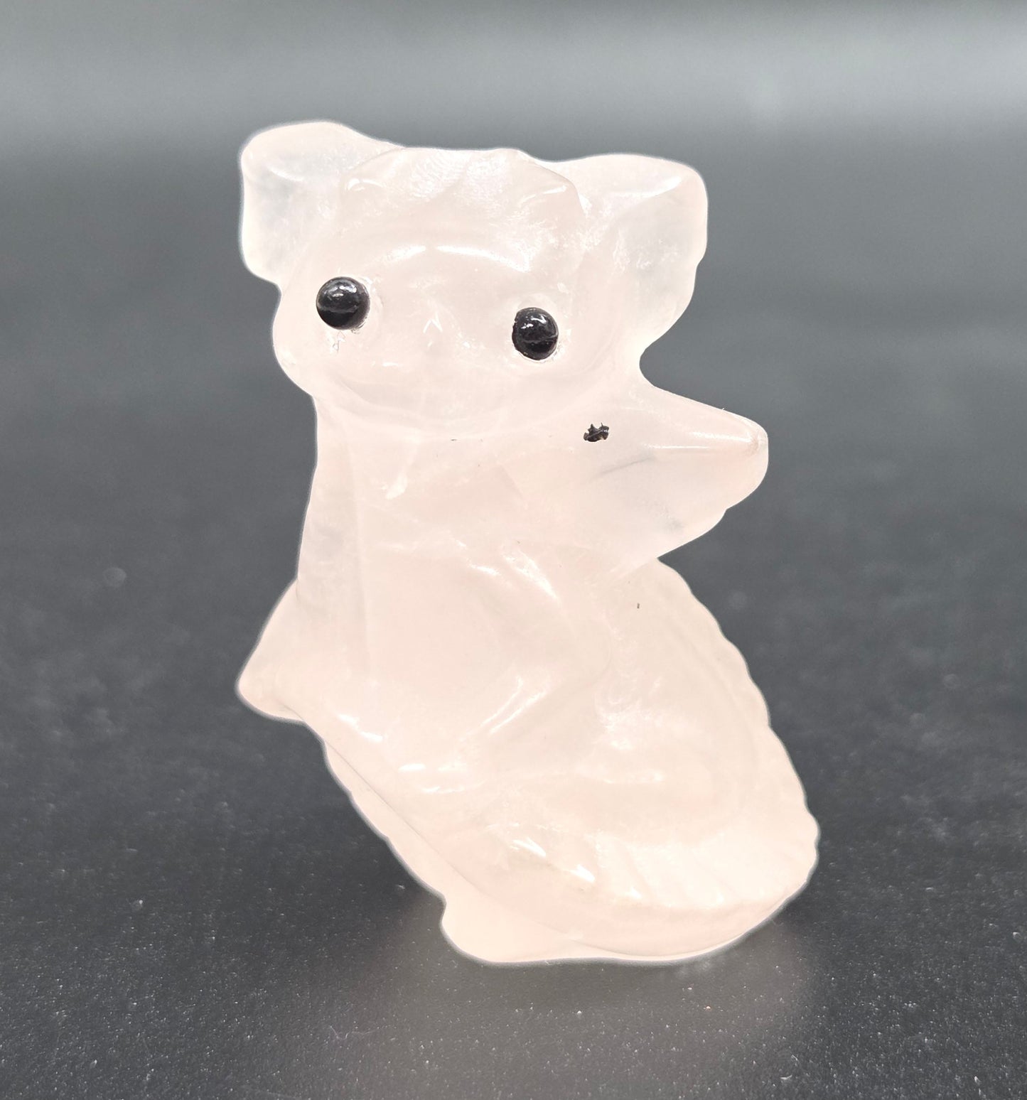 Rose Quartz dragon carving on a white background