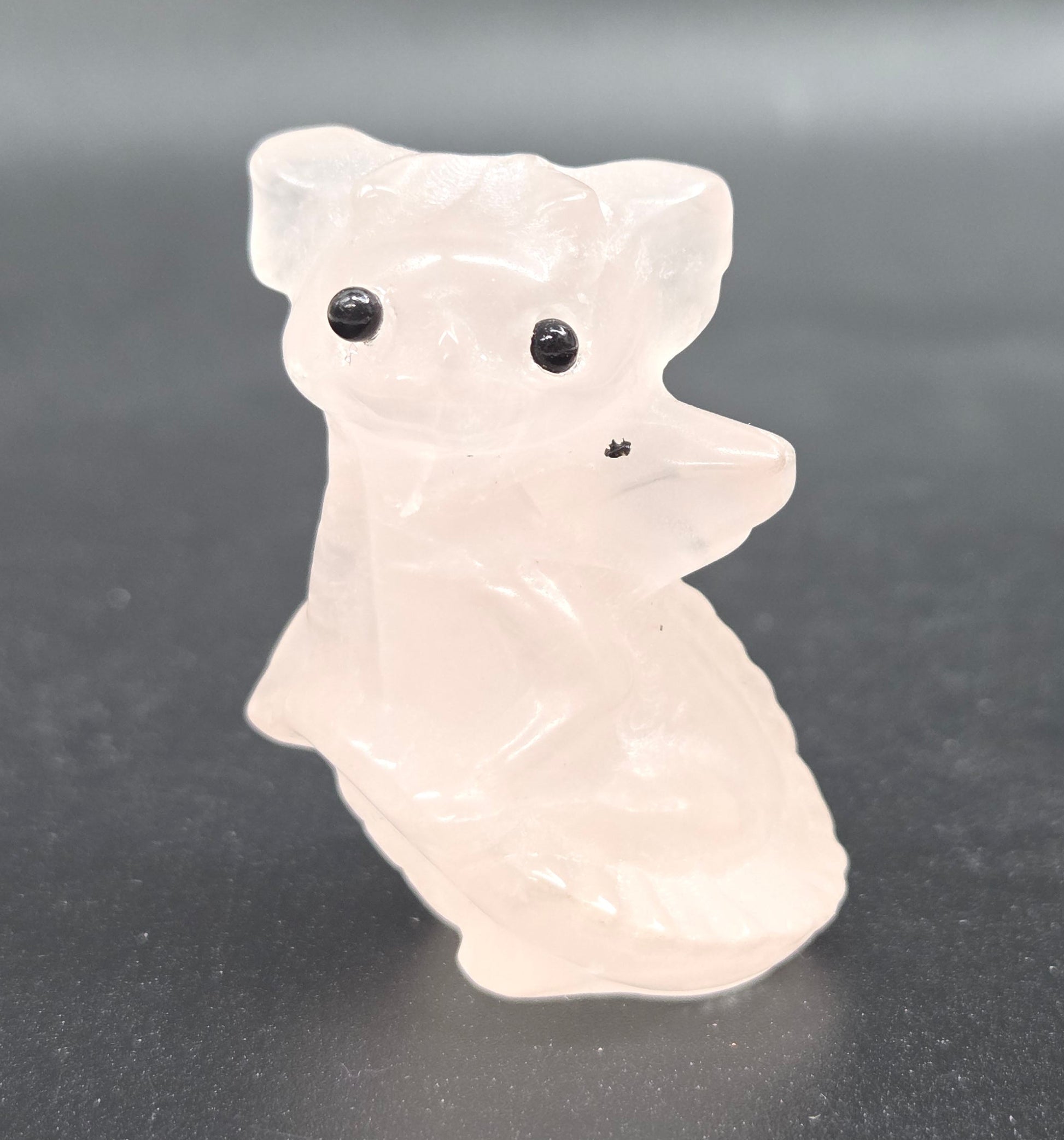 Rose Quartz dragon carving on a white background