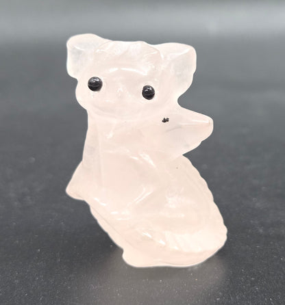 Rose Quartz dragon carving on a white background