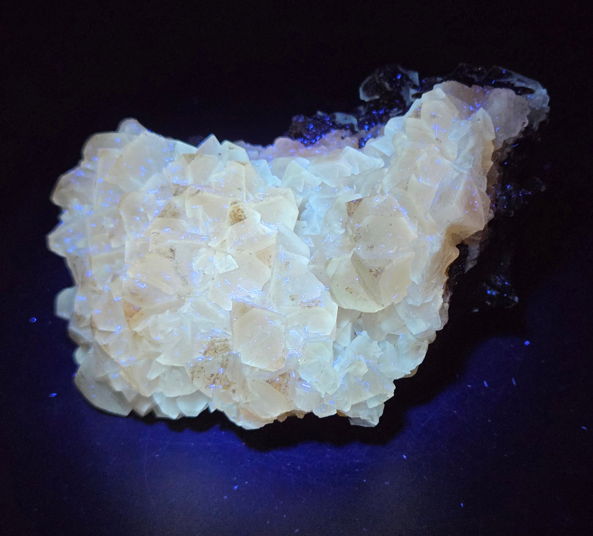 Calcite crystal specimens on a white background, with varying sizes and hues, some with a golden color and others with a darker, clouded appearance.