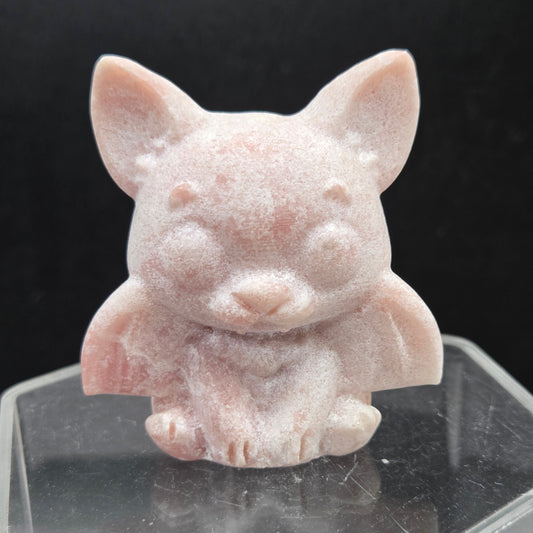 Vampire Cat pink opal carving on a black background